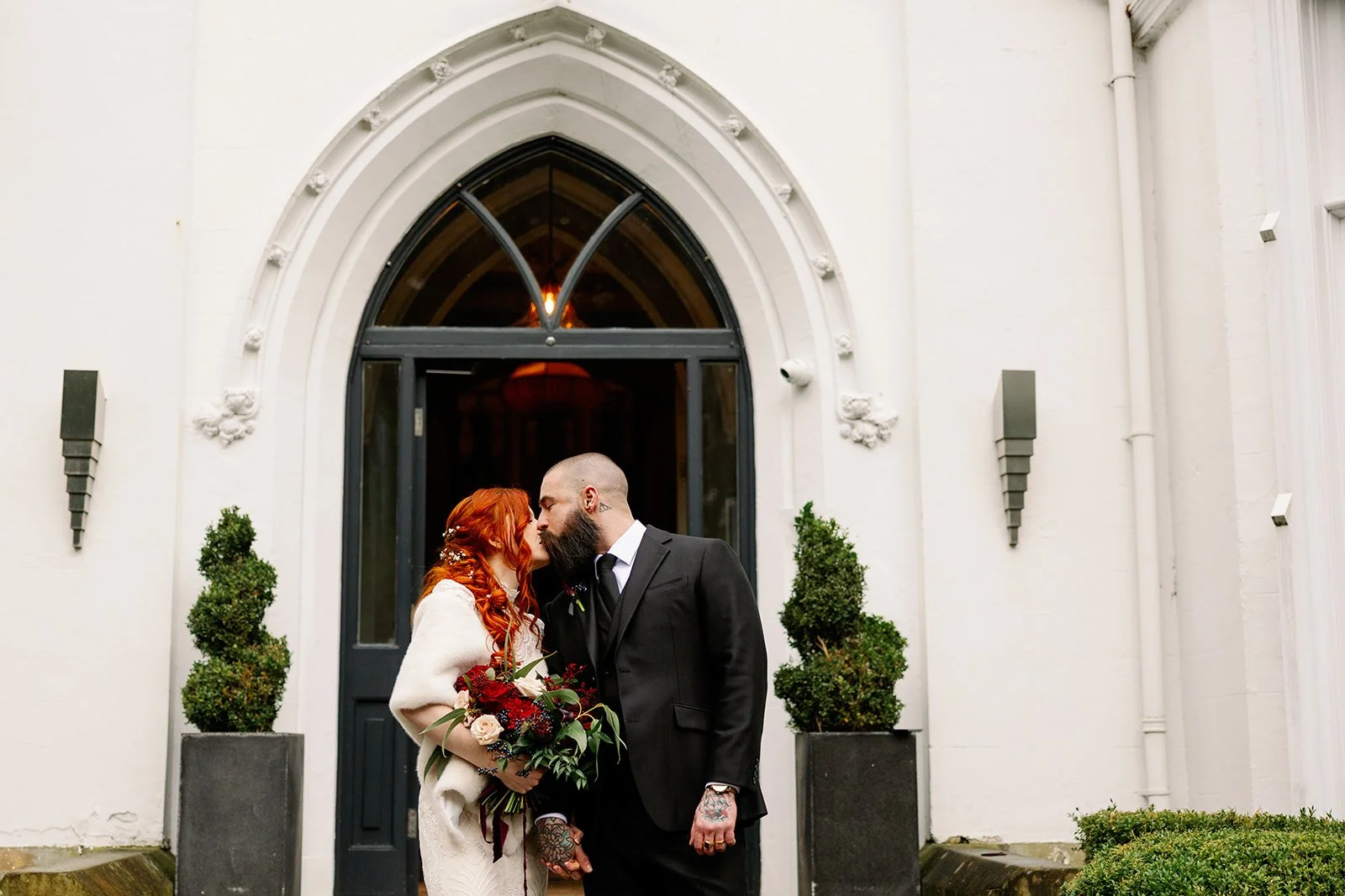 Couple kissing moody red wedding