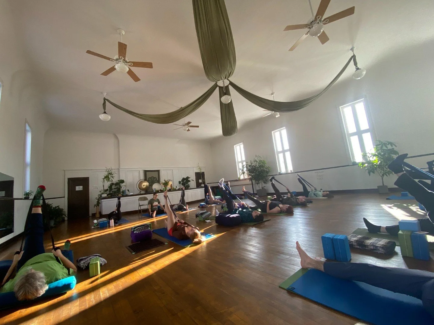 There's a powerful energy that comes from practicing in a community. When we move and breathe together, specialized brain cells called mirror neurons enhance learning and synchronize our efforts, making each individual's practice more potent. This co