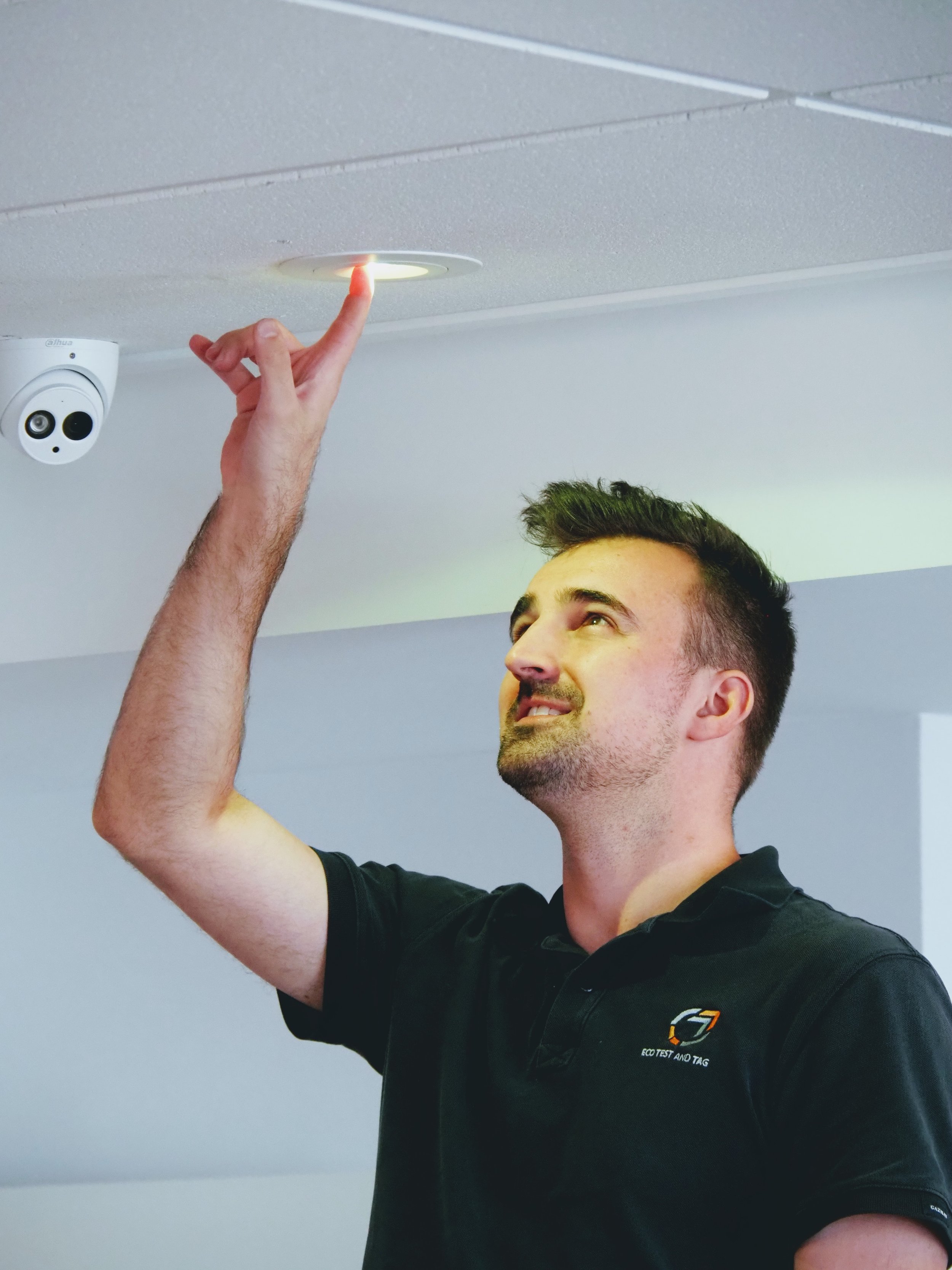 Technician Testing Exit Emergency Light