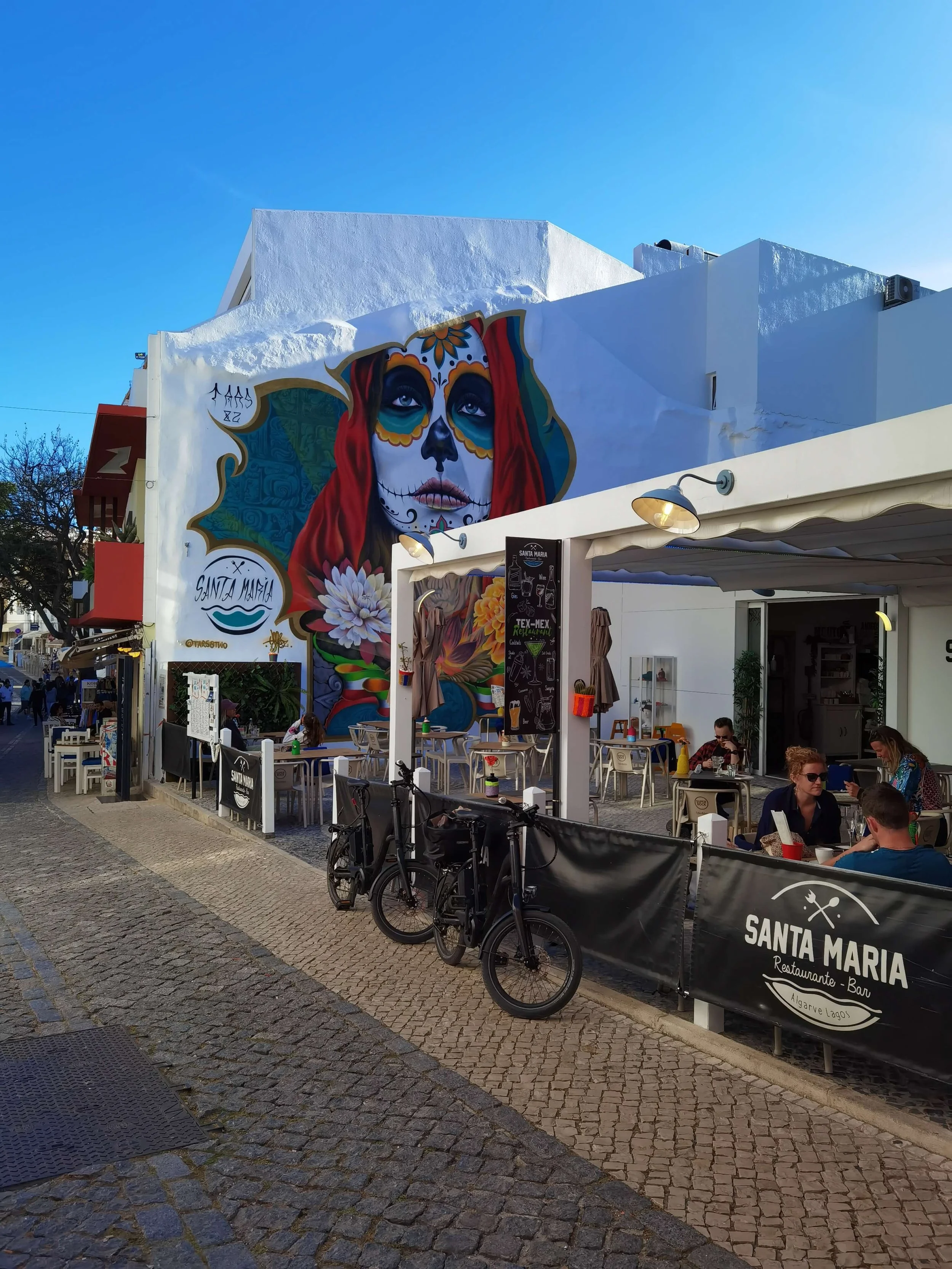 Santa Maria restaurant in Lagos old town with colourful Day of the Dead street art mural