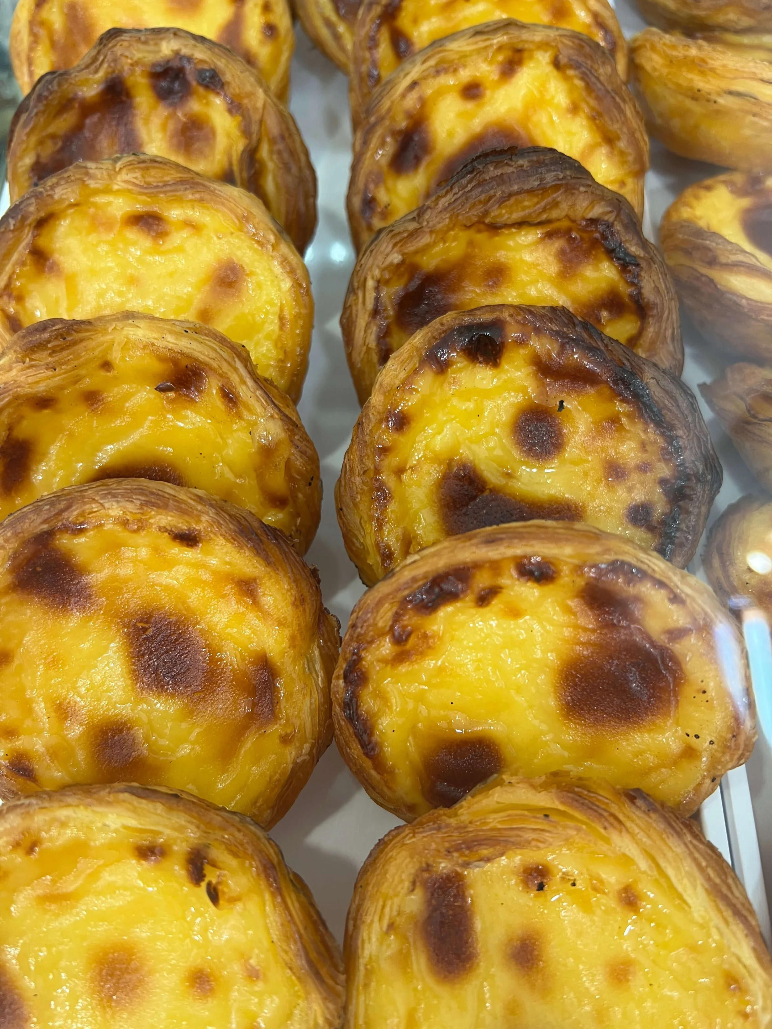 Freshly baked Pasteis de Nata with golden custard at Delicias Lagos Algarve
