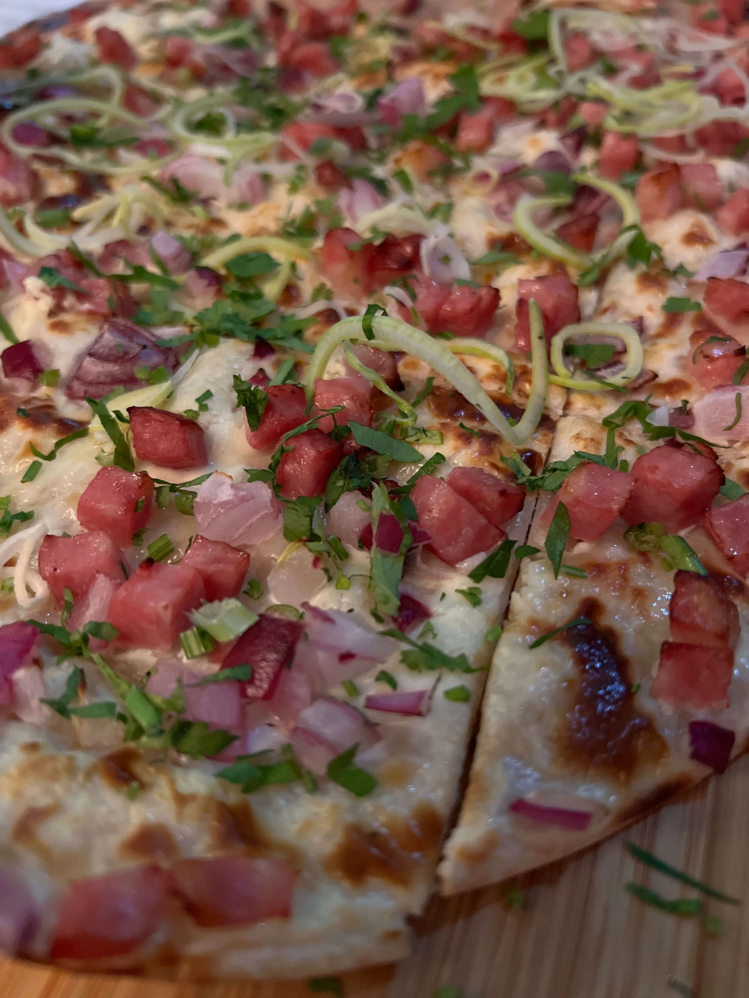 Close up of freshly baked Flammkuchen at Munich restaurant Lagos Algarve