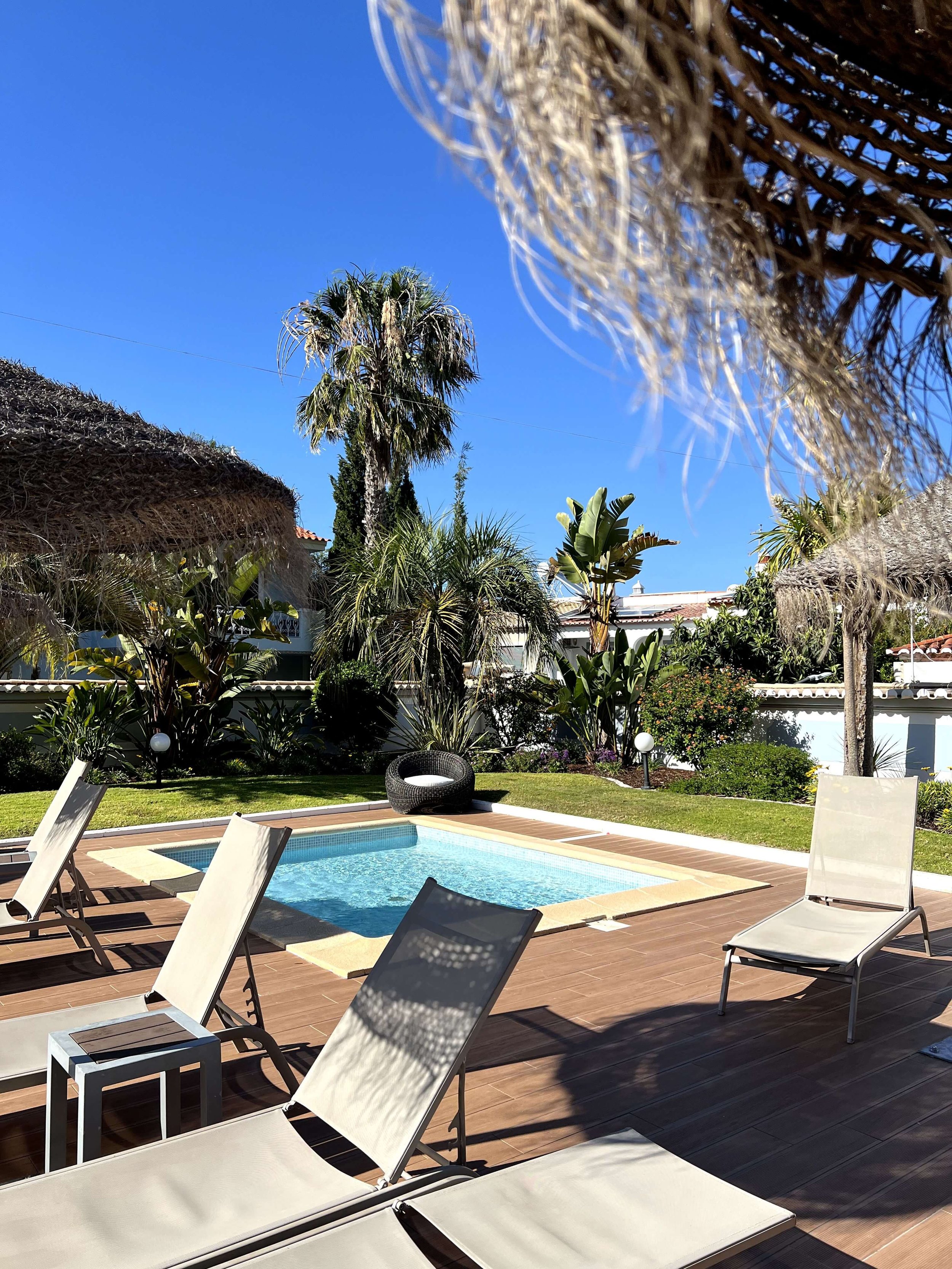 Shaded kids pool area with garden and straw parasols at Casbah Lagos
