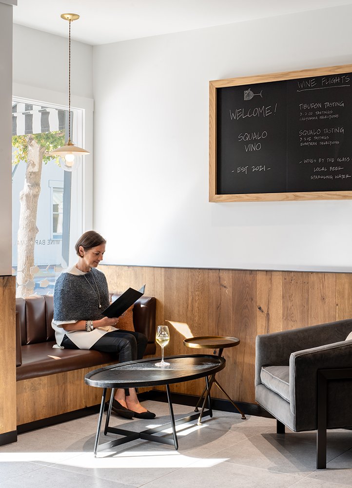 Hand-lettered chalkboard wine menu and TV to watch games at Squalo Vino, downtown Tiburon's favorite neighborhood wine bar