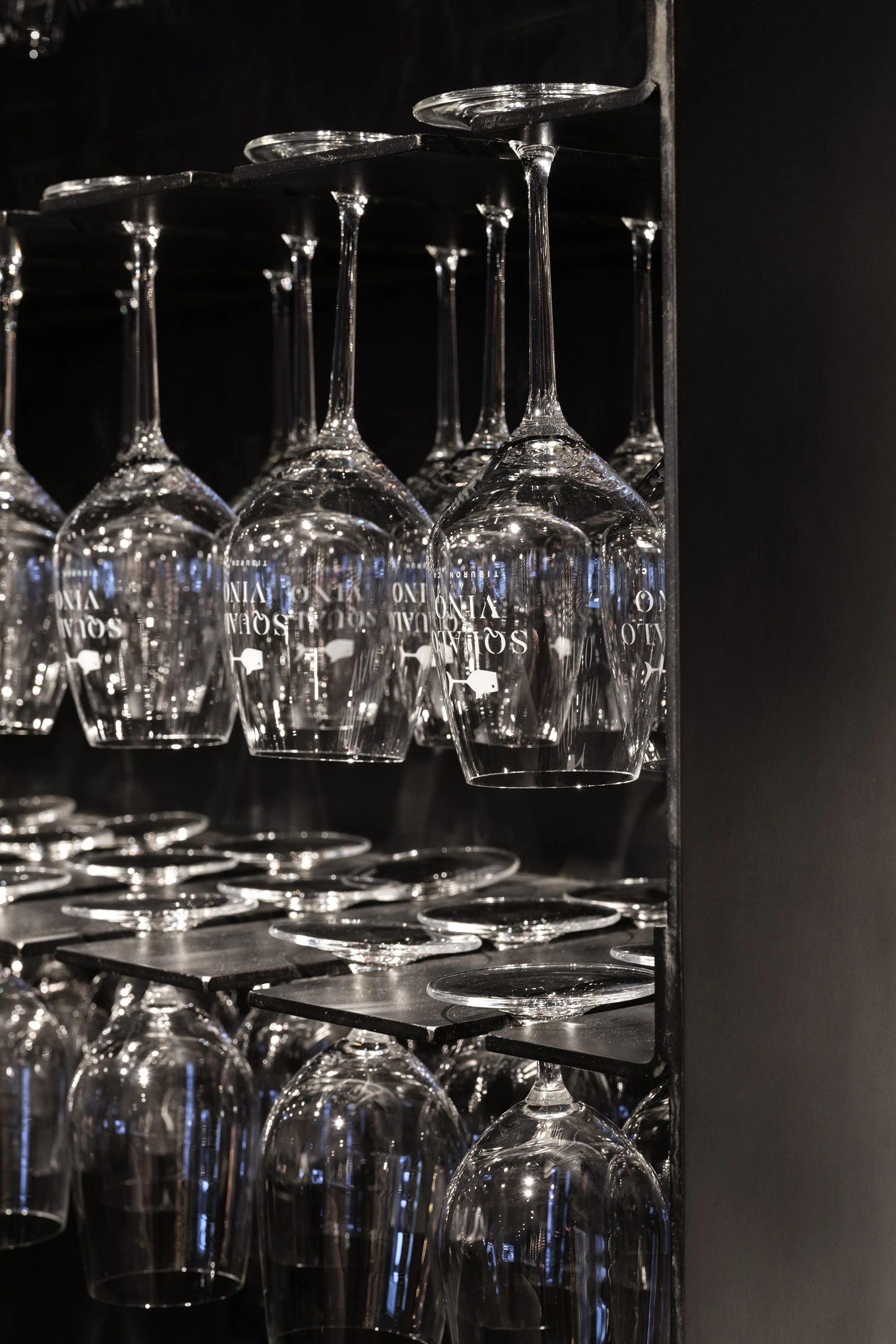 "Detail shot of wine glasses at Squalo Vino, a boutique wine bar interior design in Tiburon, California"