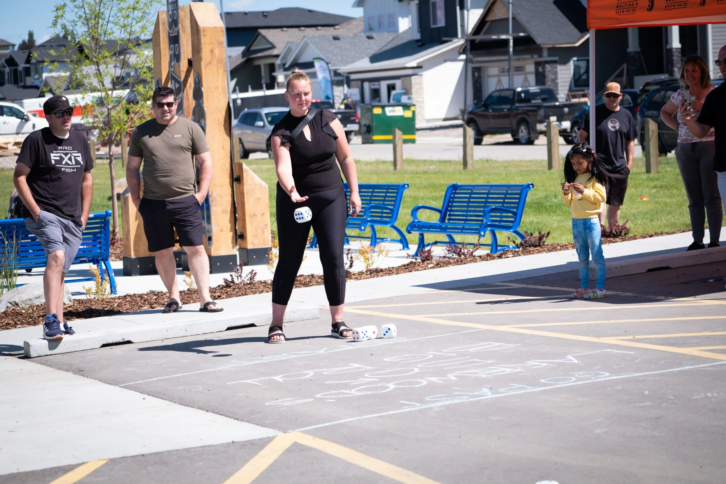 Image of adults and children playing games in a playground