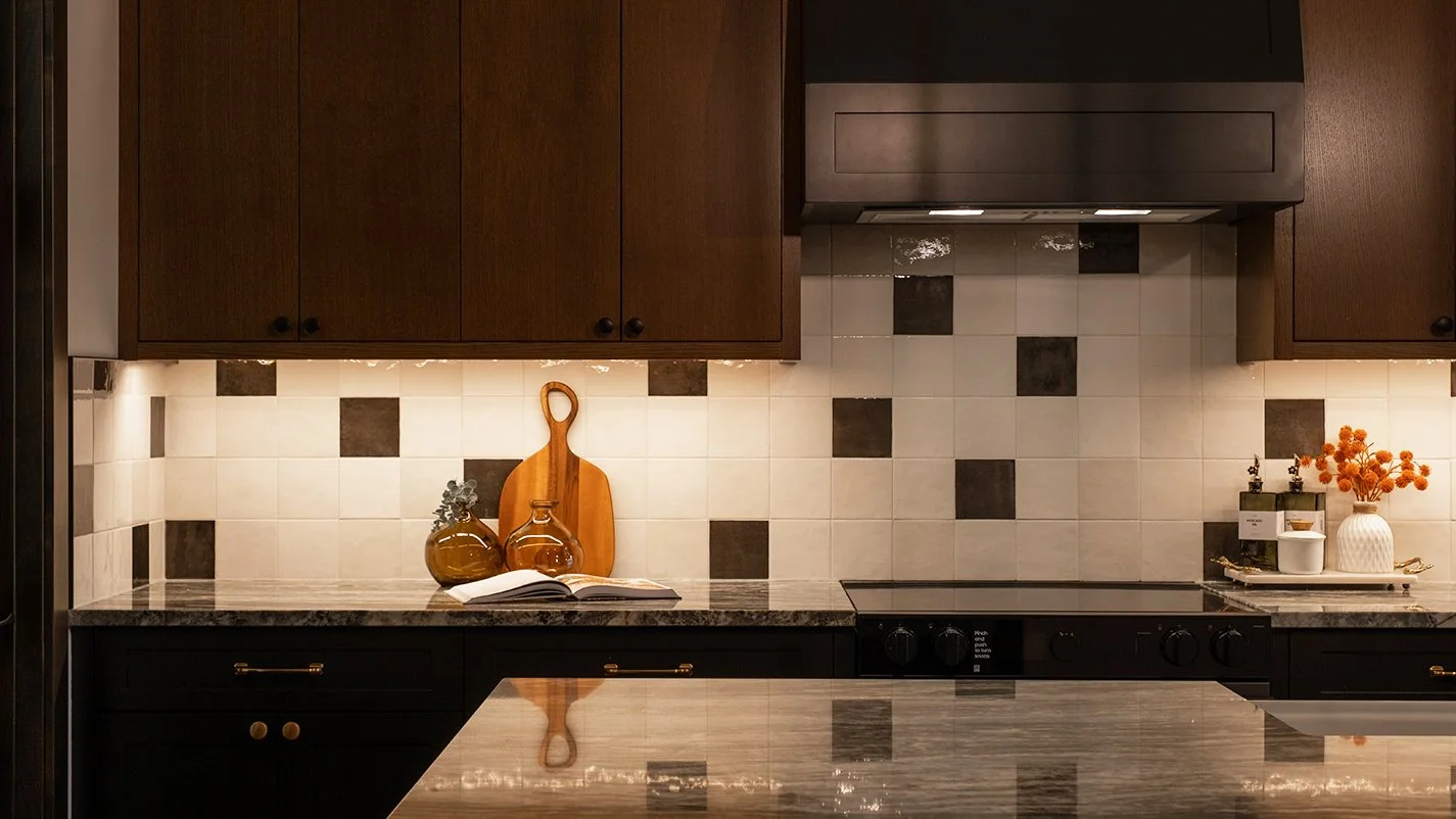 Image of kitchen cabinets and under-lit back splash