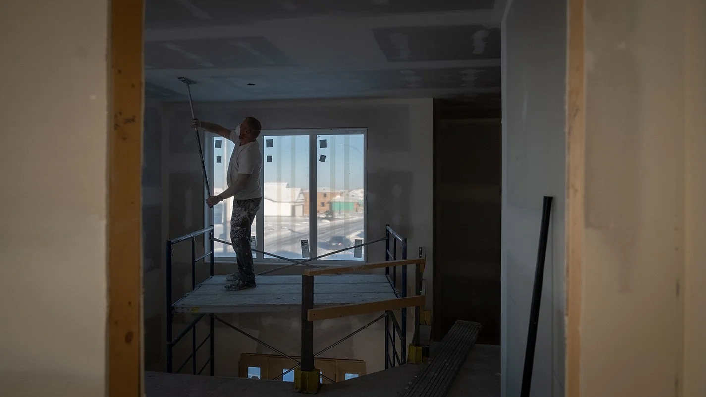 Image of contractor painting new home ceiling