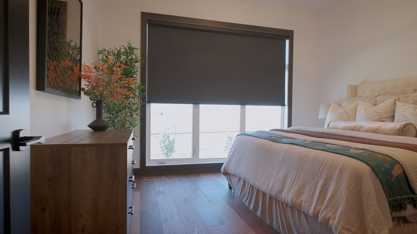 Image of bedroom. Bed, dresser and large window with blind half way down