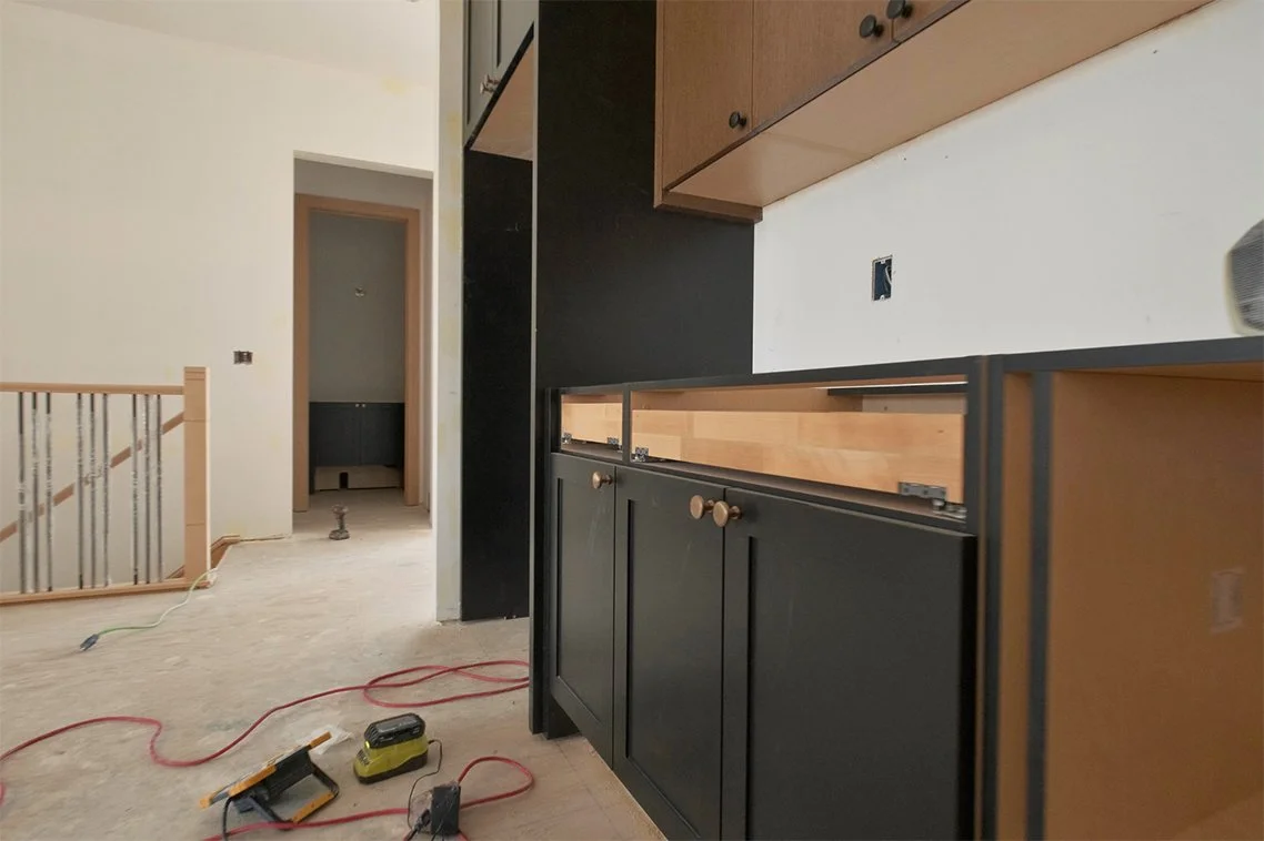 Image of kitchen cabinets being installed