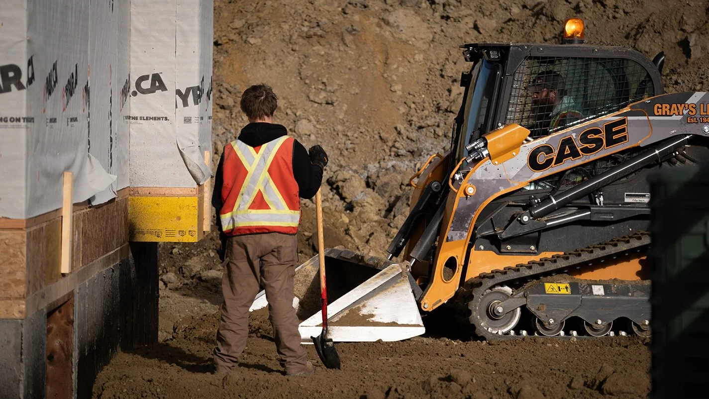 Image of contractors preparing ground with a small excavator