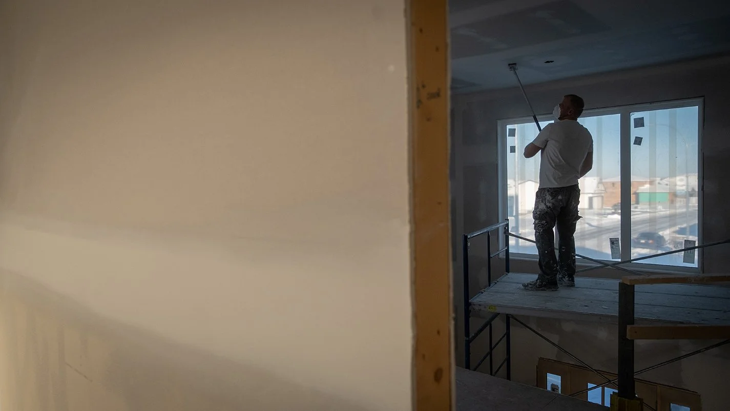 Image of contractor painting new home ceiling