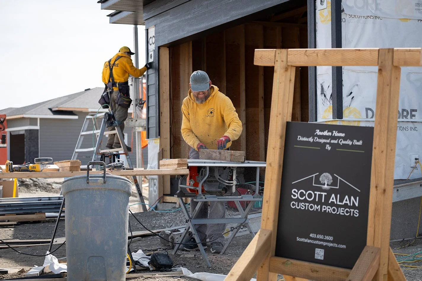 Two tradesmen constructing a home