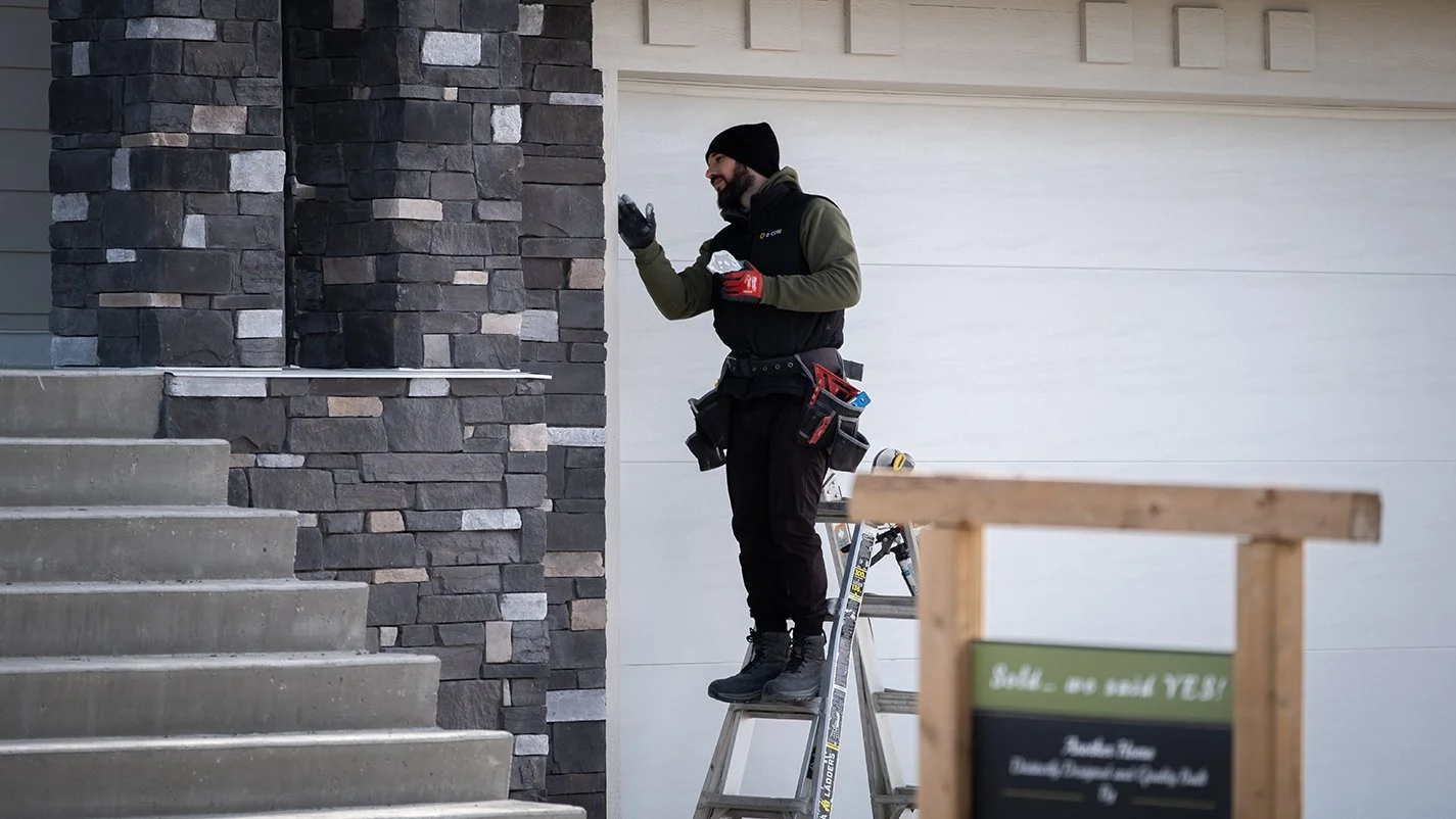 Contractor making finshing touches to an exterior rock facade
