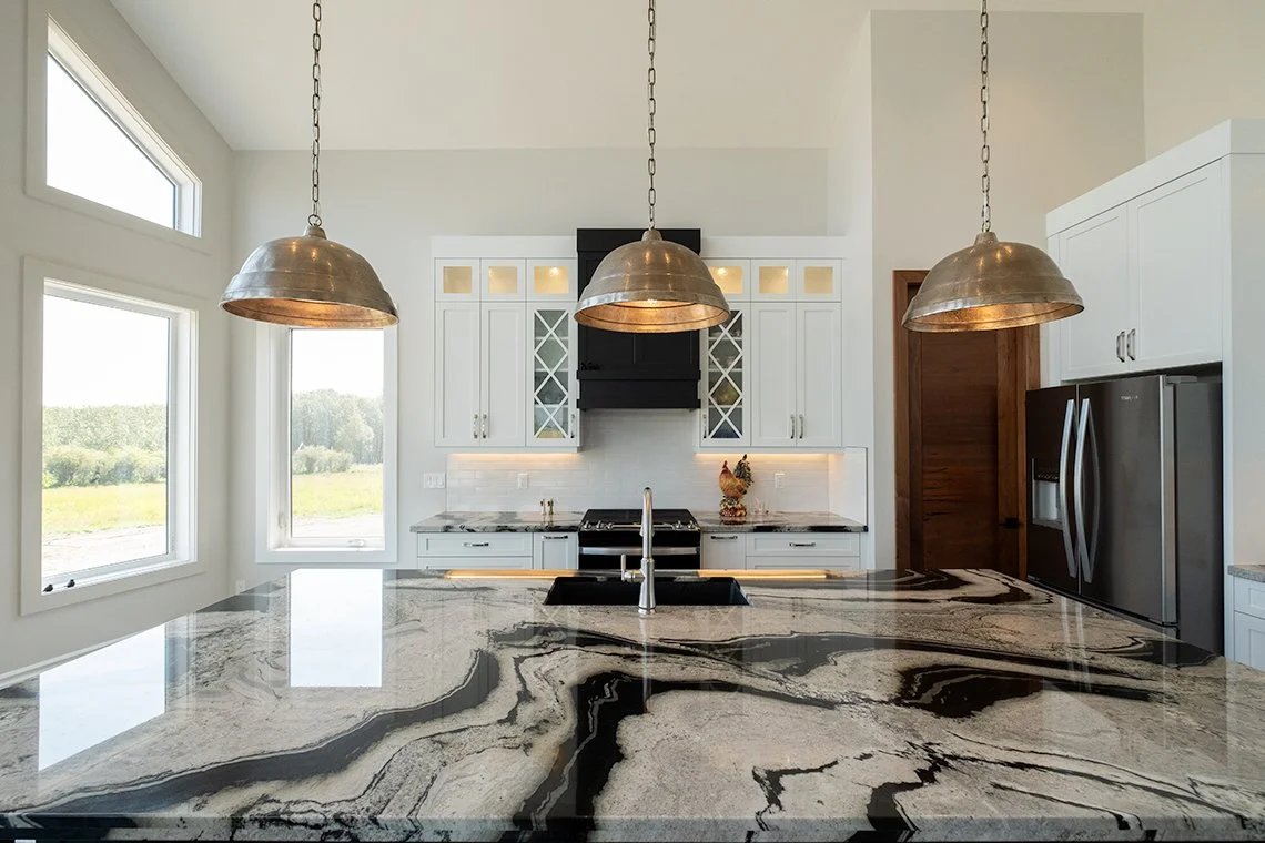 Image of kitchen with view over island counter to stove and cabinets