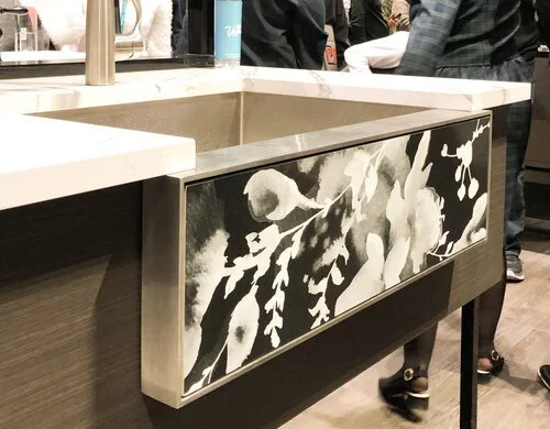 A black and white floral patterned apron front sink from Kohler.