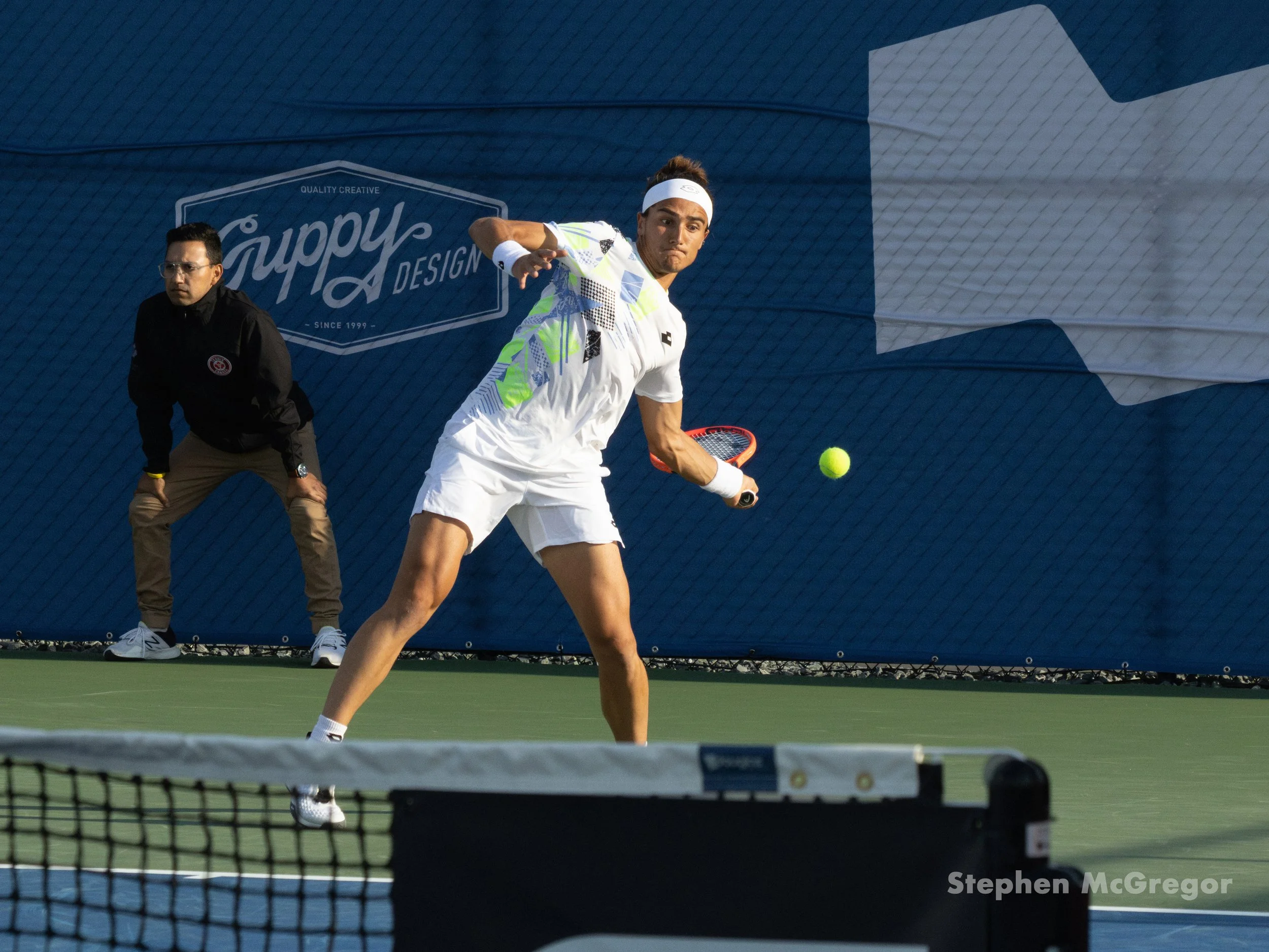 Mattia Belucci swing at a tennis ball while on the court