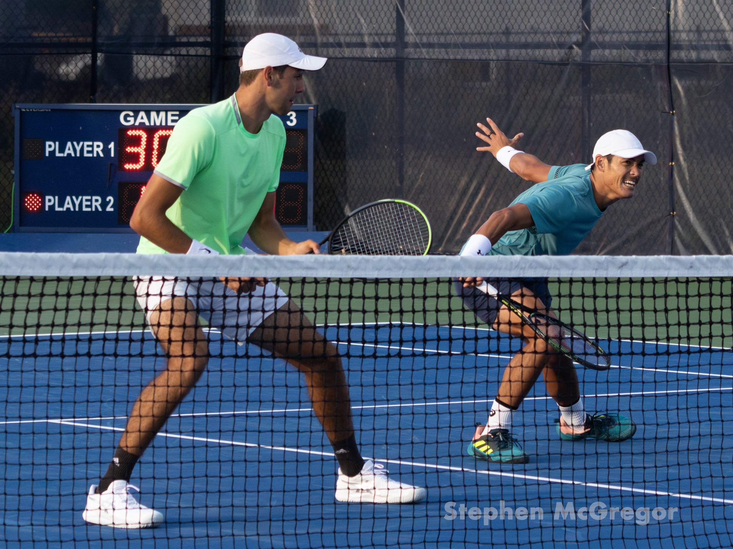 Chris Rodesch and Thai-son Kwiatkowski assume position on the court in their doubles tennis match