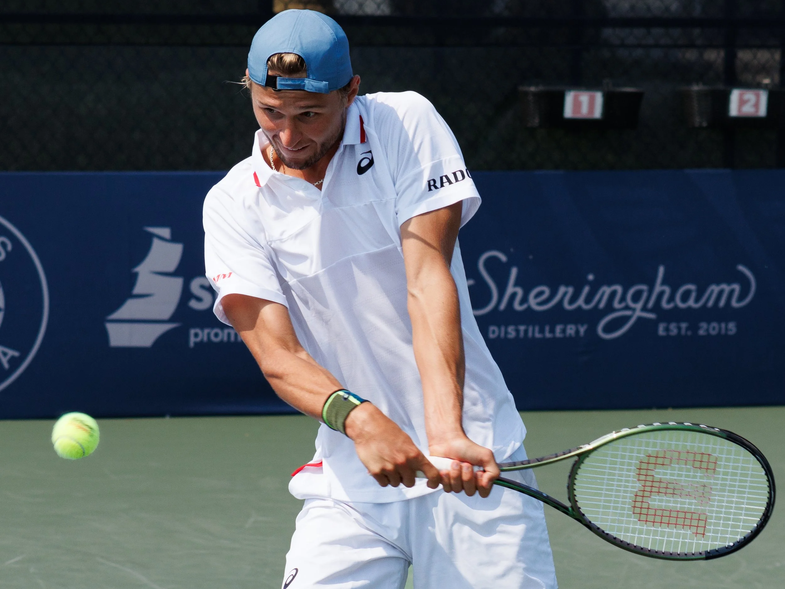 Leandro Riedi hits a tennis ball during his match.
