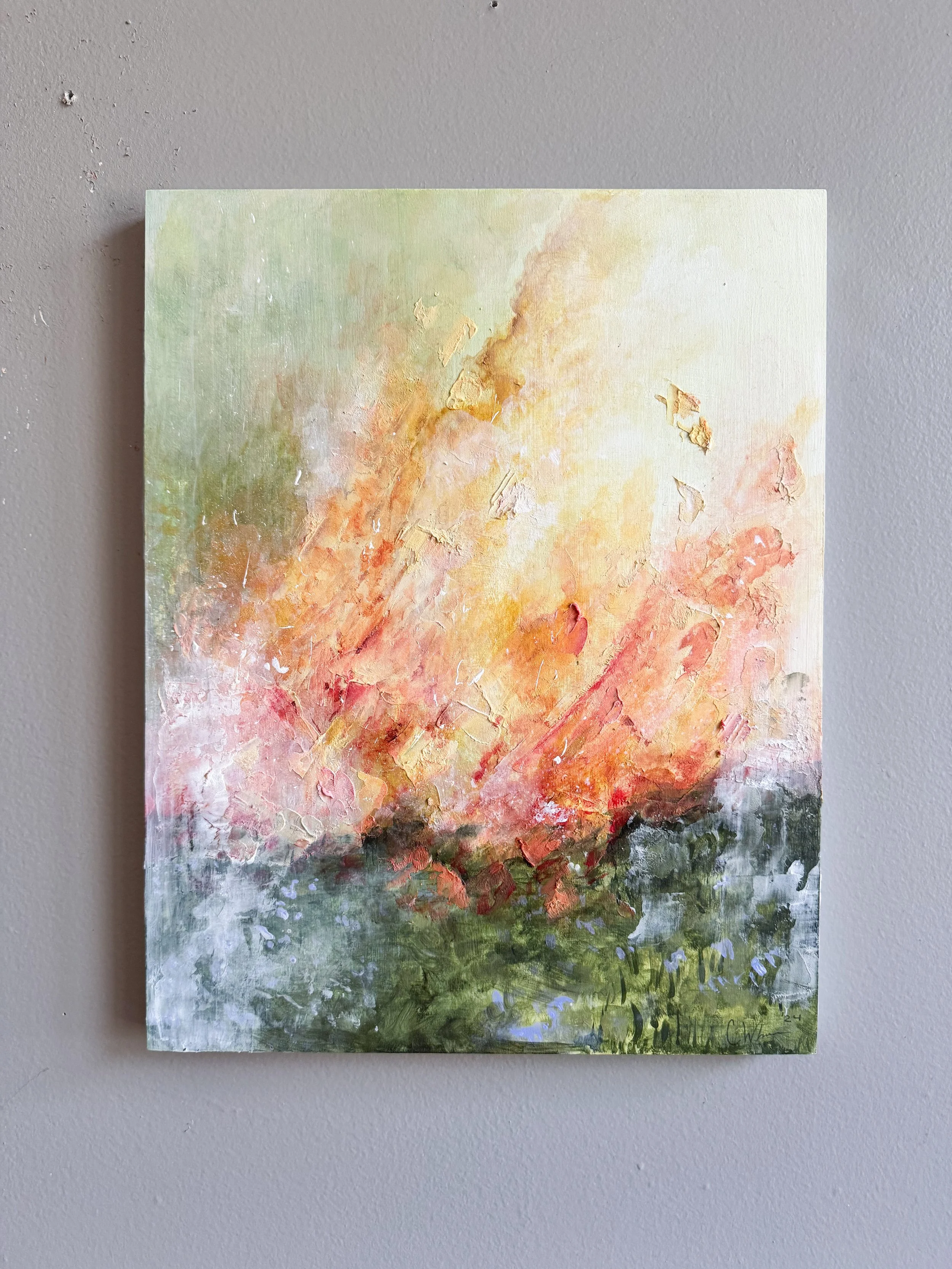 Abstract painting with green, yellow, orange, and pink brushstrokes on a canvas