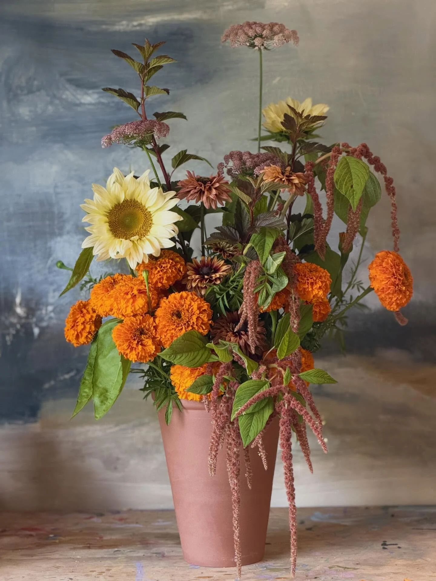 Vase arrangements for your workplace, party or event.

Marigold, sunflower, rudbeckia, amaranthus, queen annes lace &amp; ninebark in terracotta.

Dm to enquire or visit my website for info and orders.