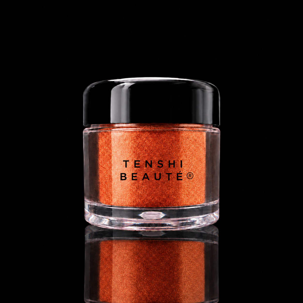 Tenshi Beauté Safran Cuivré loose pigment in a clear pot with a glossy black lid and centred black logo.