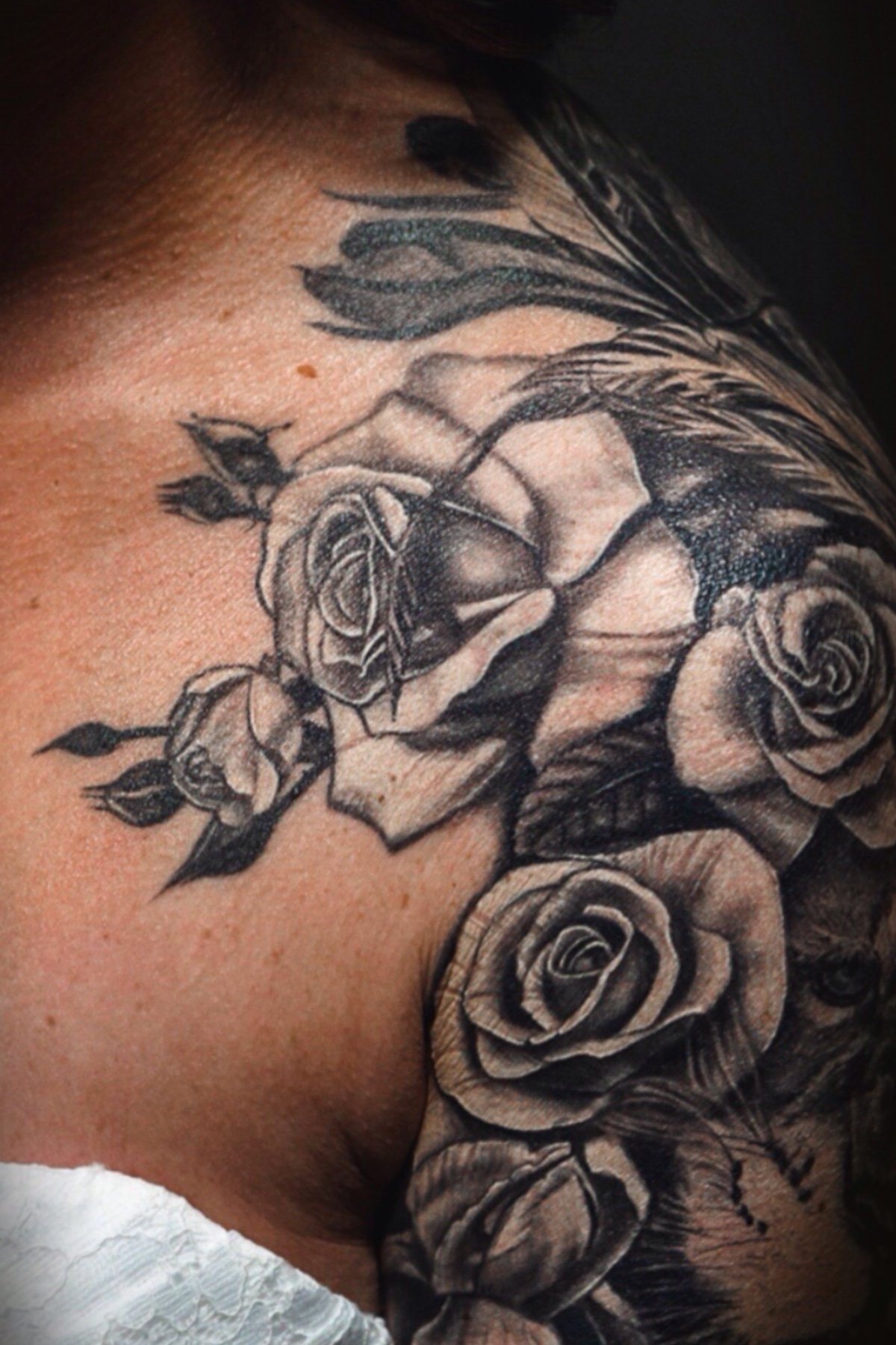 Black and grey rose tattoos on a shoulder by Daniel Stewart at Signature Rose Professional Tattooing in Muncie Indiana.