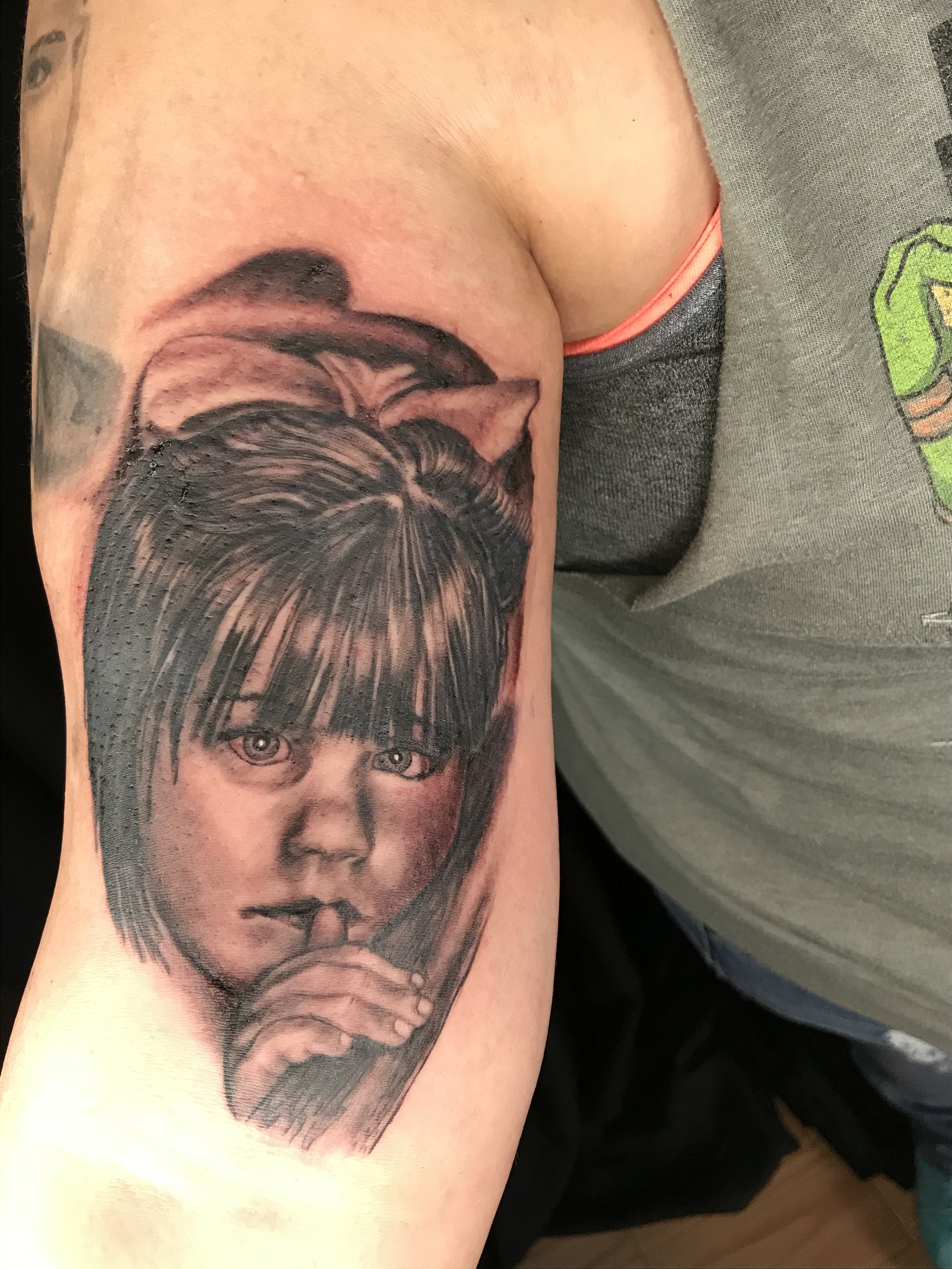Black and grey tattoo portrait of a child done by Daniel Stewart at Signature Rose Professional Tattooing in Muncie Indiana.