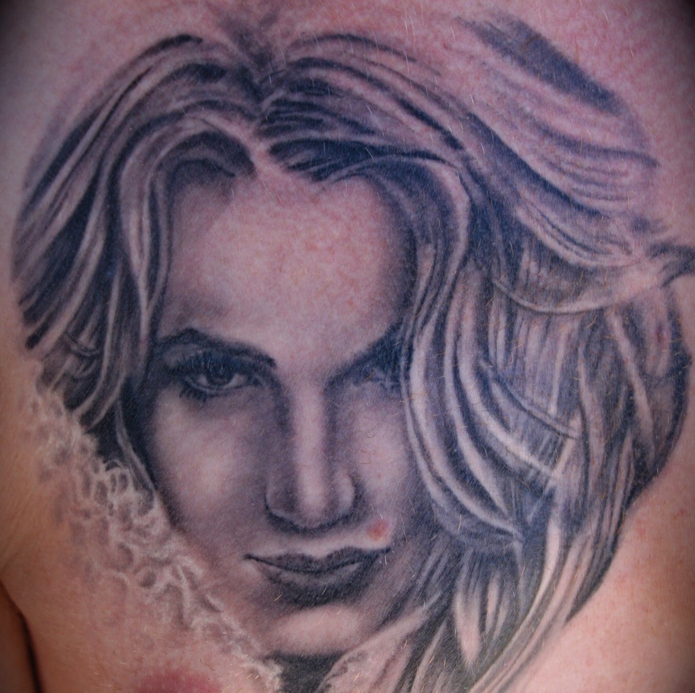 Black and grey portrait of a woman done by Daniel Stewart at Signature Rose Professional Tattooing in Muncie Indiana.