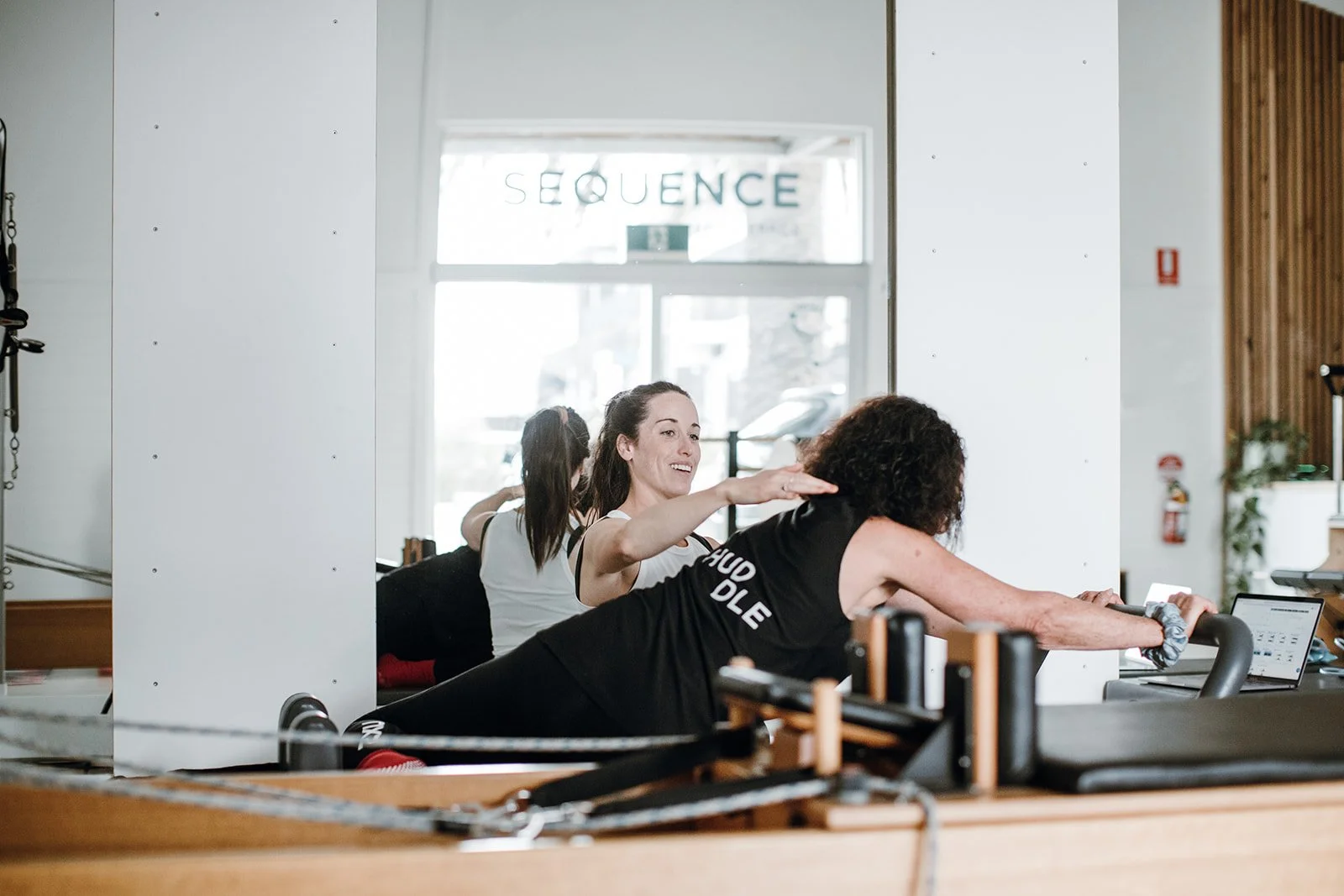 Women on a pilates reformer being instructed by a qualified osteopath