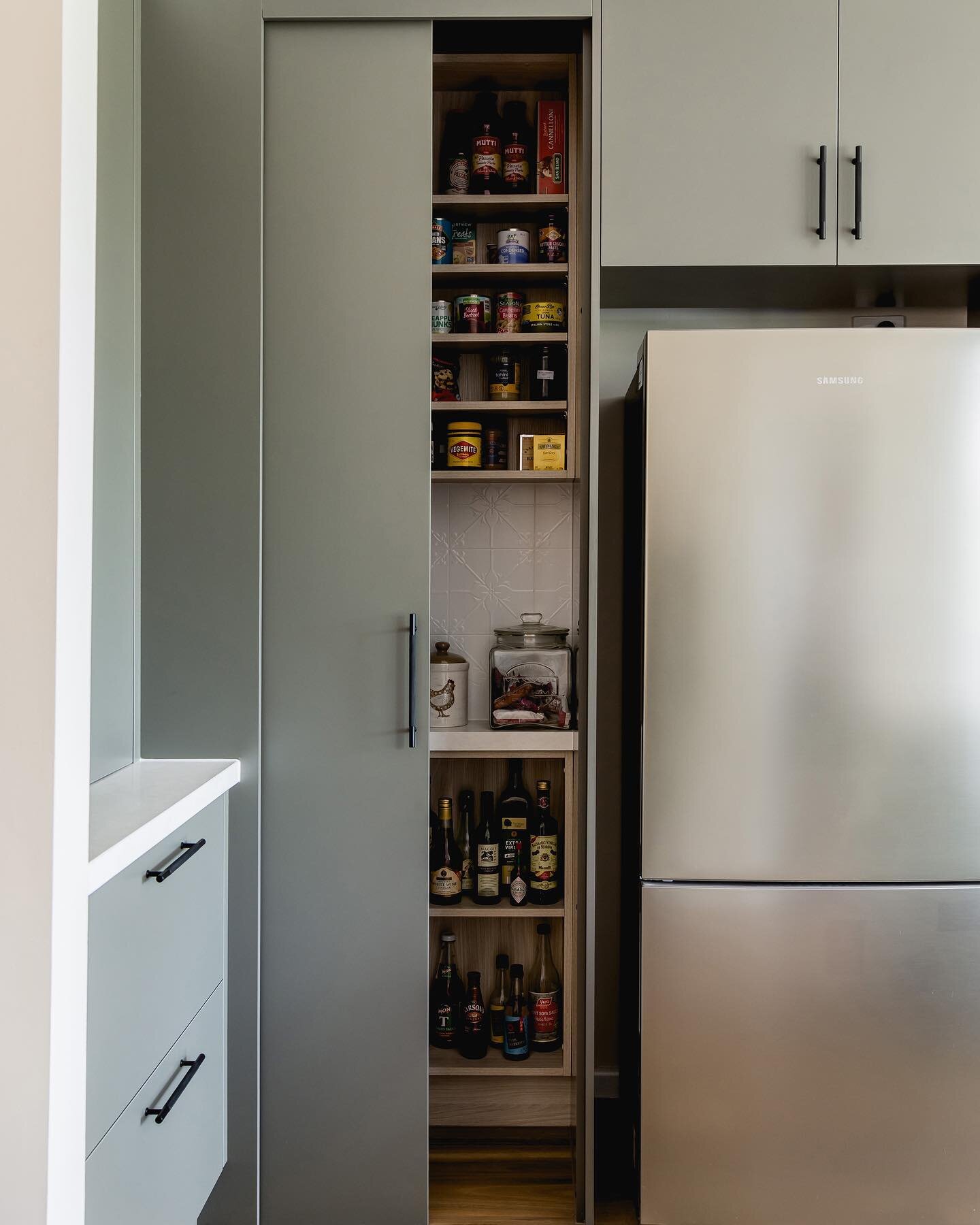 Transform your kitchen with a sleek rectangular corner pantry.  This corner solution provides ample storage for all your essentials while making the most out of your kitchen's unused space or tricky corner. With a sliding door, timber laminate shelve