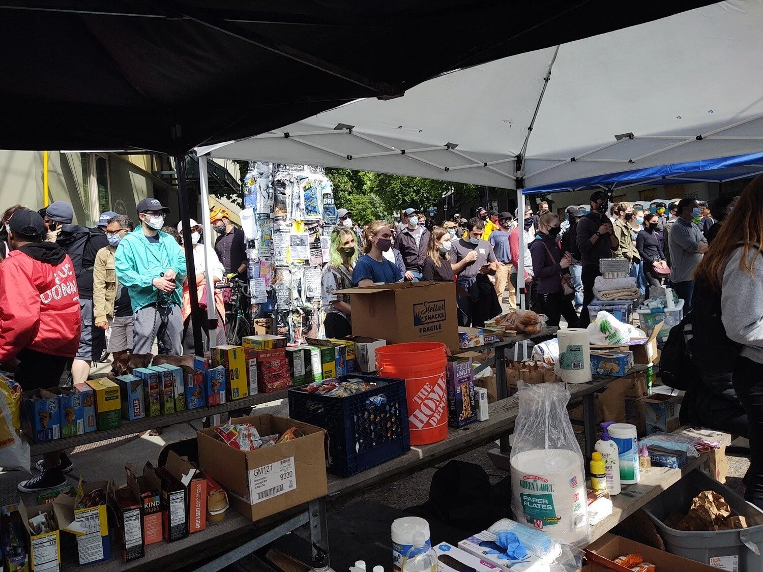 One week into the Capitol Hill Autonomous Zone, a food tent at 12th &amp; Pine is surrounded by people