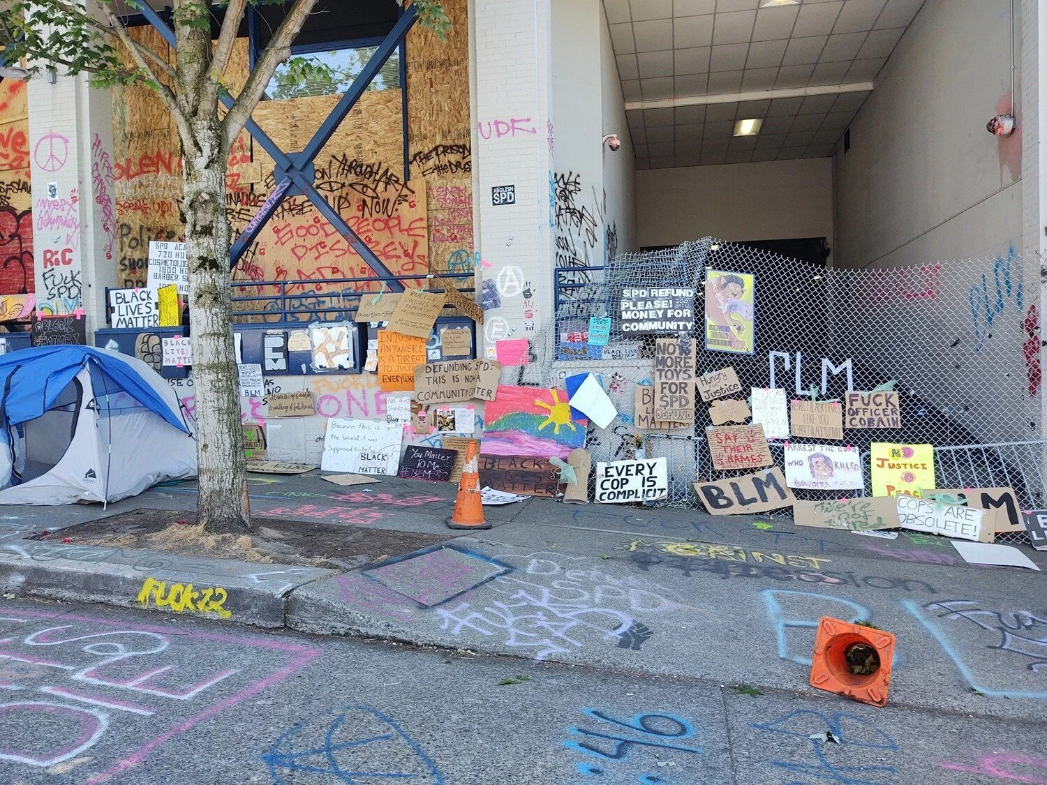 Signs cover the Pine St side of precinct.
