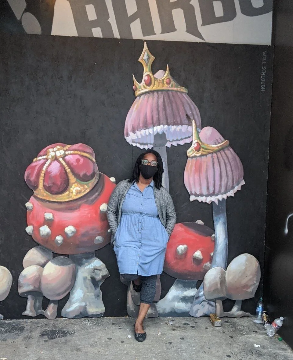 Tarika Powell stands in front of a mural in Capitol Hill on July 1, 2020, after CHOP was shut down without any demands met.