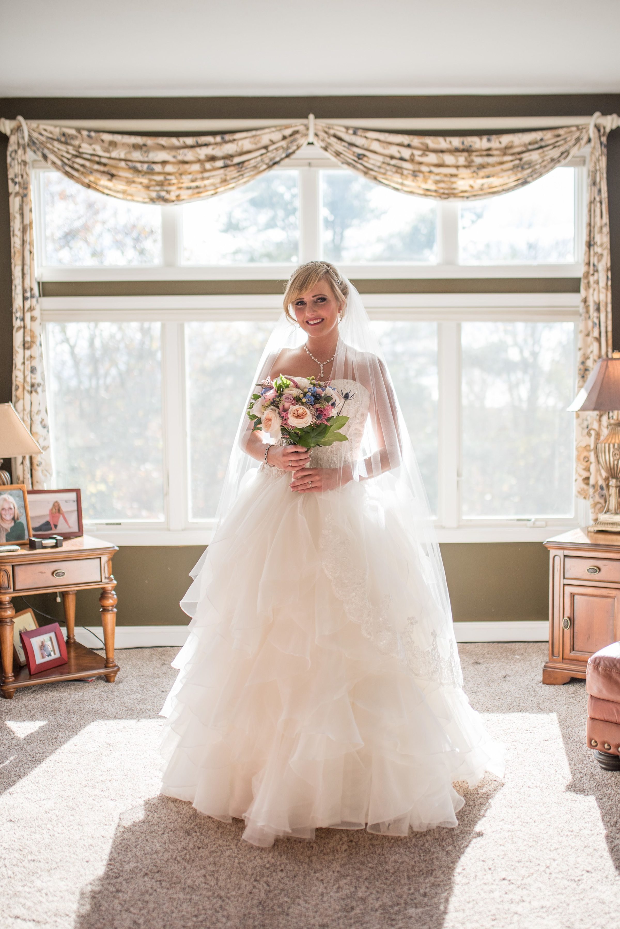 Bride in her wedding gown while getting ready for Cape Cod wedding
