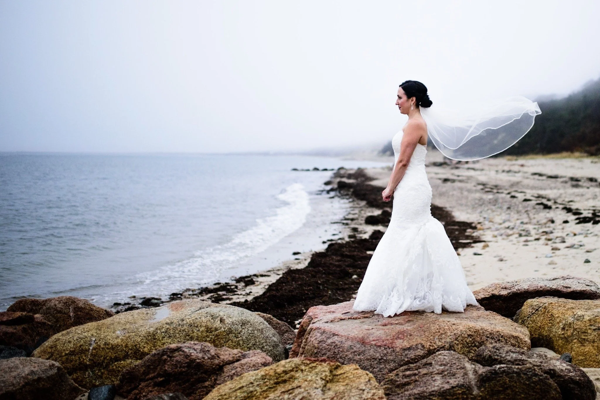 new-england-wedding-photographer-editorial-bridal-portrait-on-rocky-beach-with-veil-blowing-003.jpg