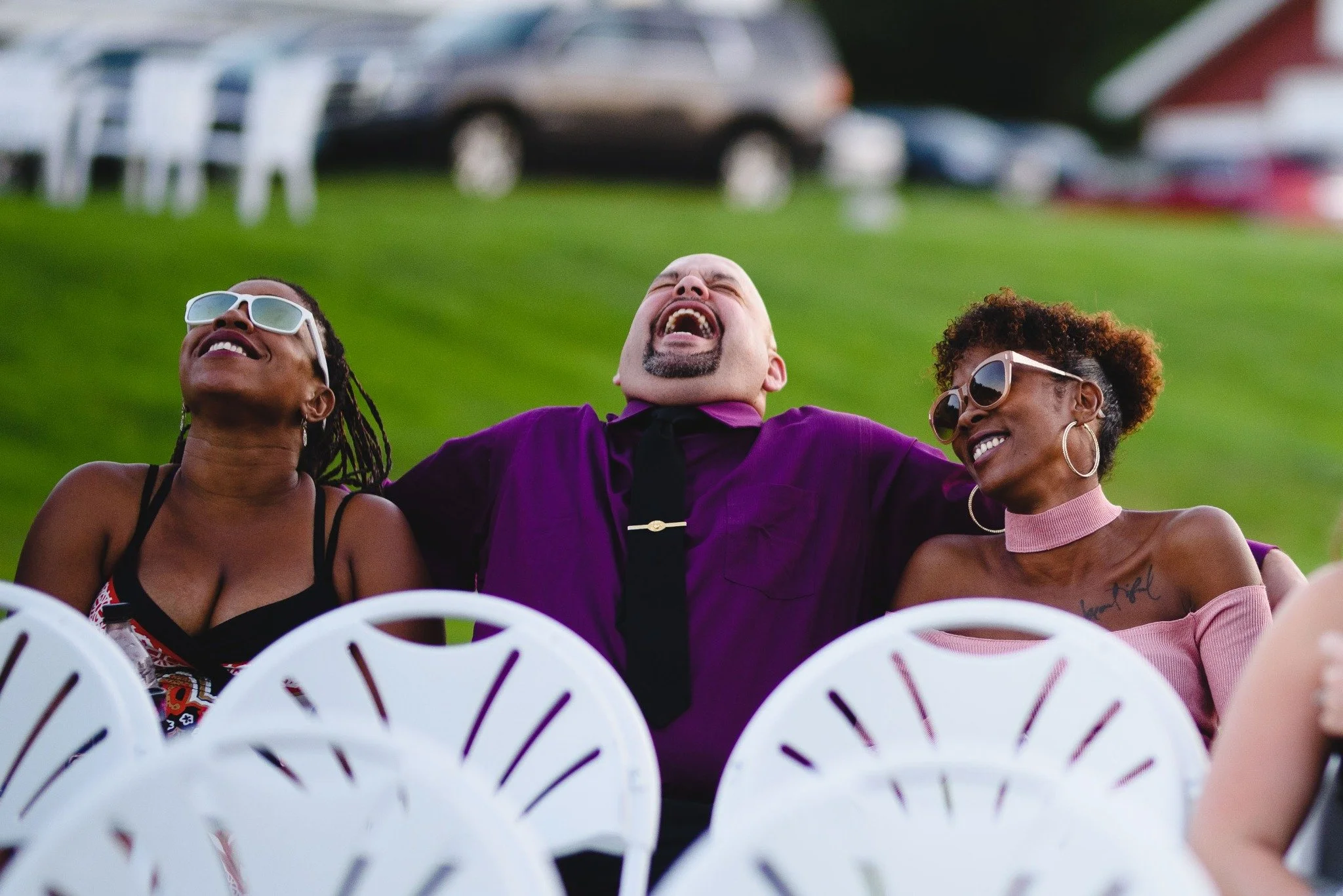 massachusetts-wedding-photographer-candid-guests-laughing-in-ceremony-seating-001.jpg
