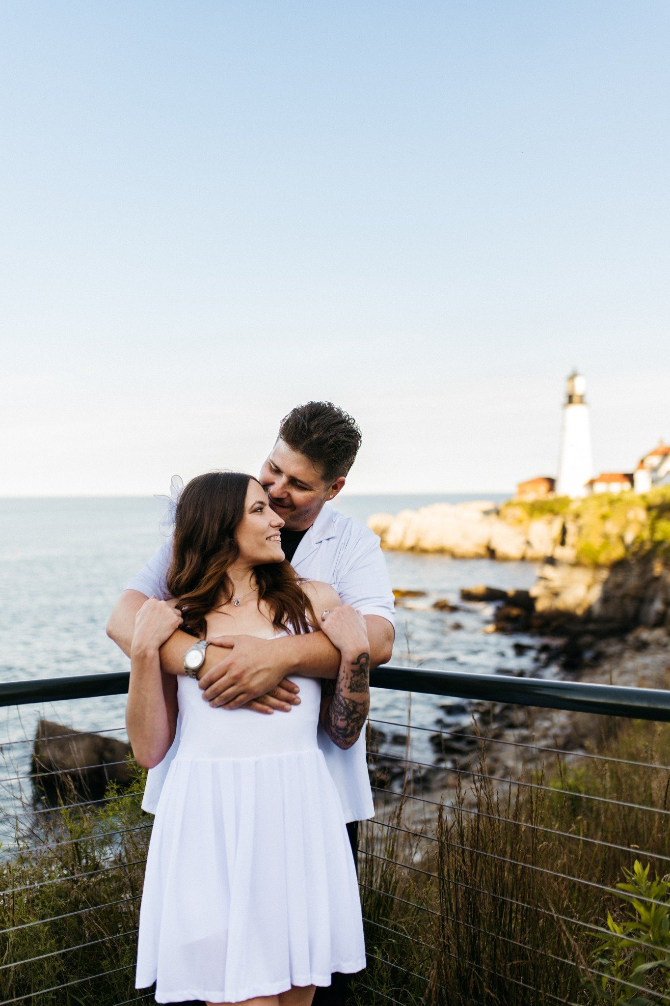 massachusetts-engagement-session-lakeside-couple-hugging-warm-sunset-light-025.jpg