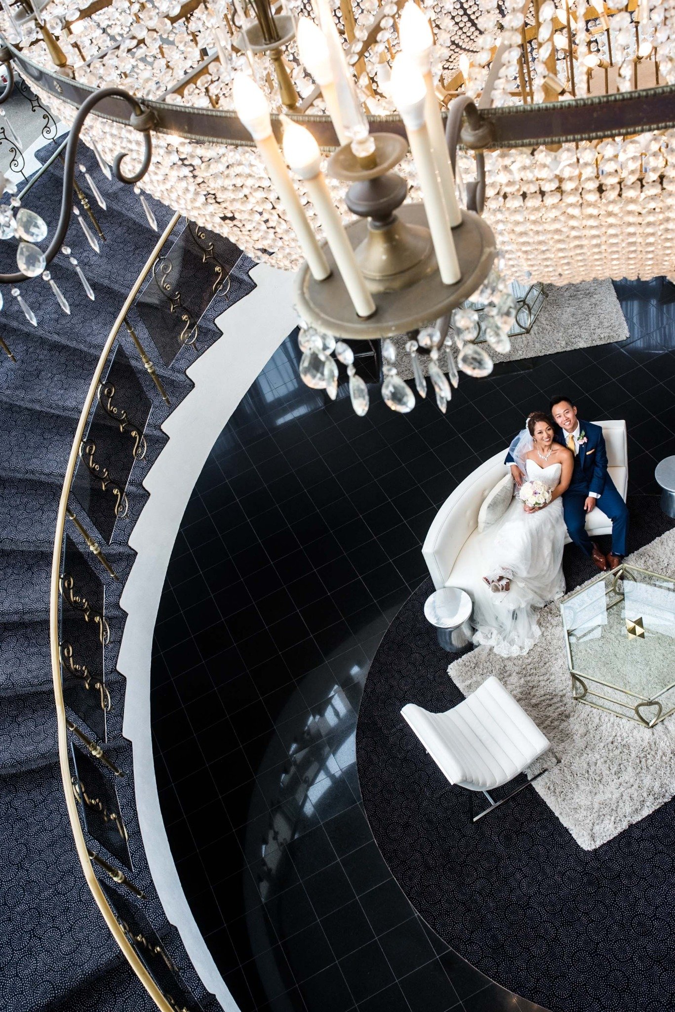 new-england-wedding-photographer-luxury-venue-overhead-staircase-portrait-with-chandelier-007.jpg