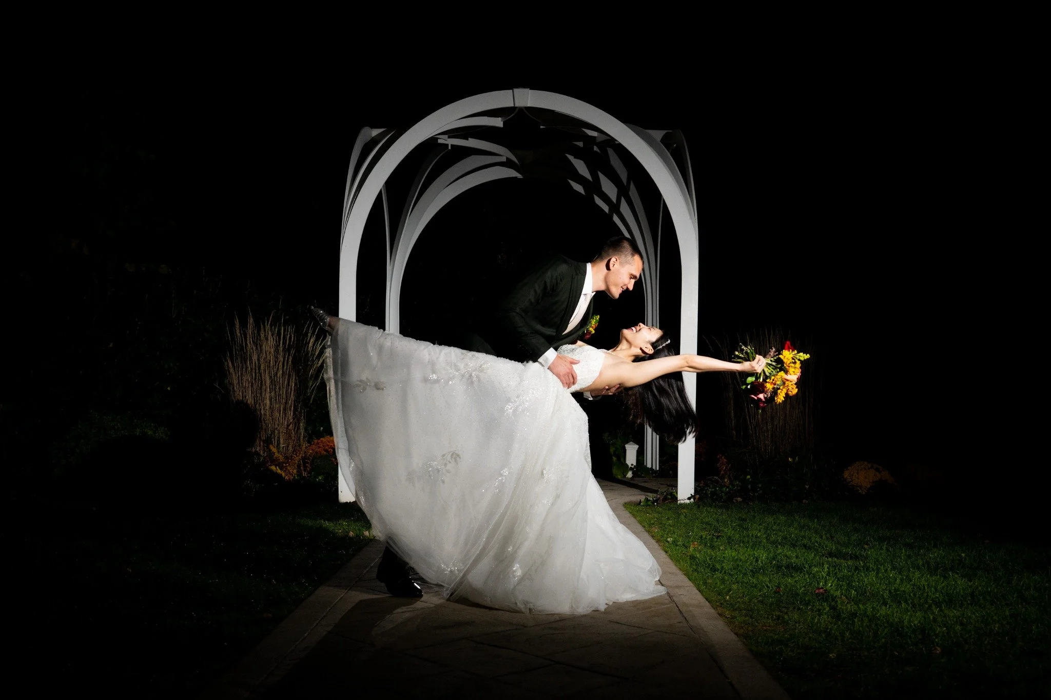 boston-wedding-photographer-nighttime-couple-dip-under-ceremony-arch-046-2.jpg