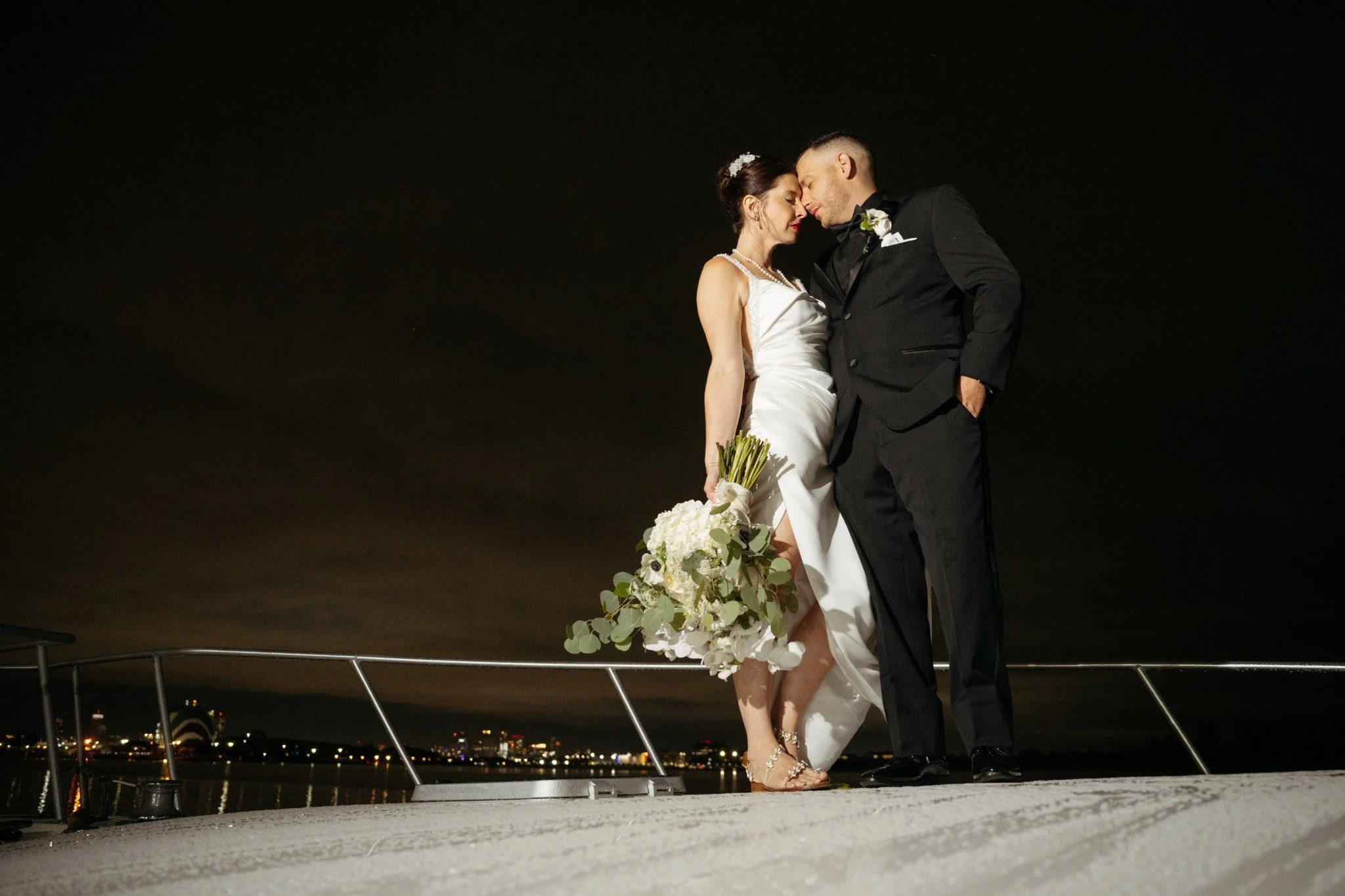 new-england-wedding-photographer-nighttime-couple-portrait-on-boat-city-skyline-038.jpg
