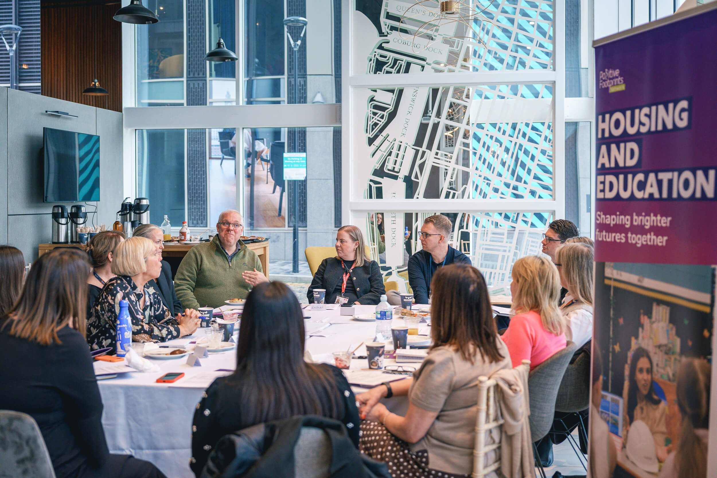 Delegates seated around tables during a professional networking session.