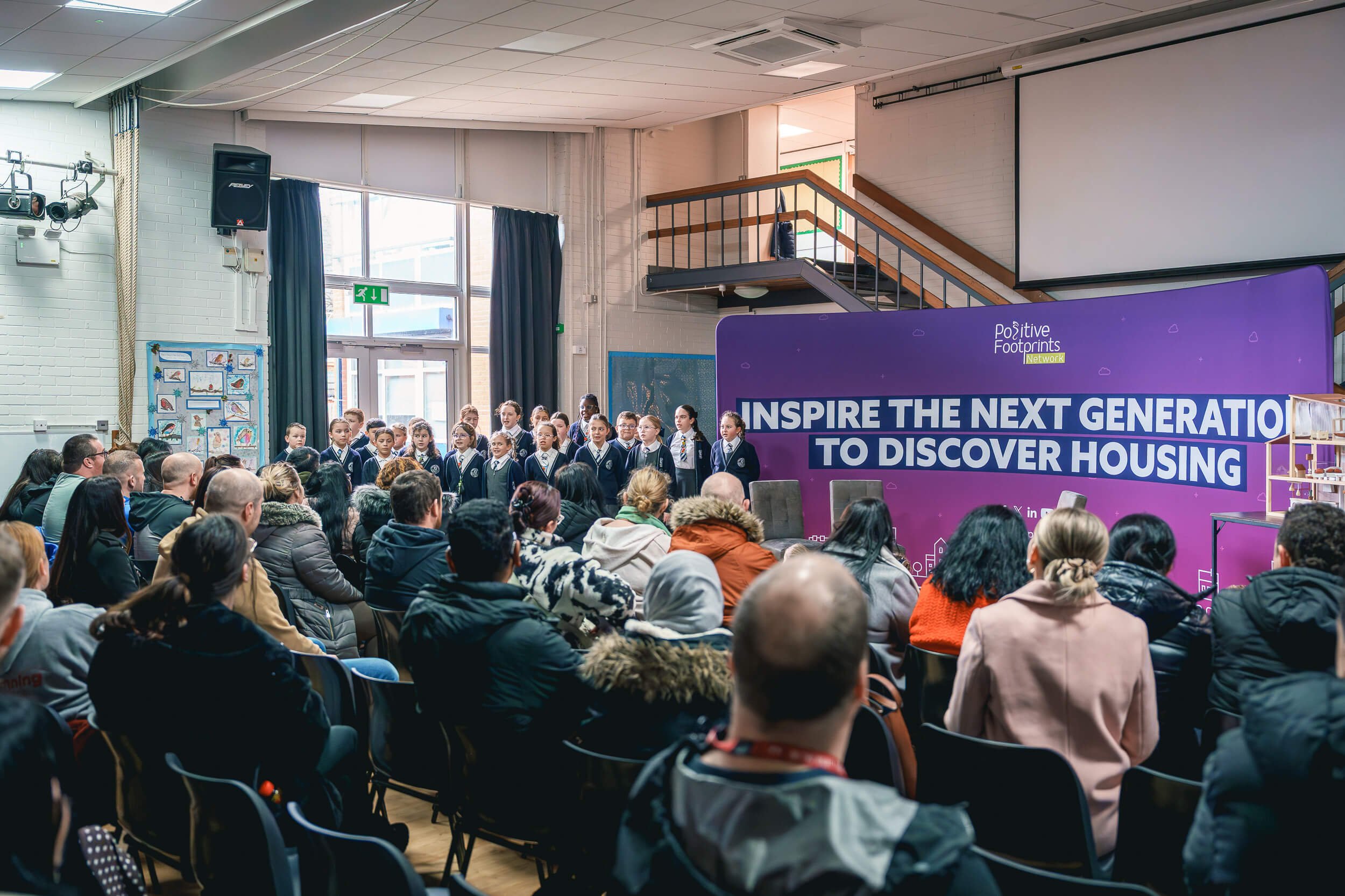 Audience listening to speakers during a community engagement event.