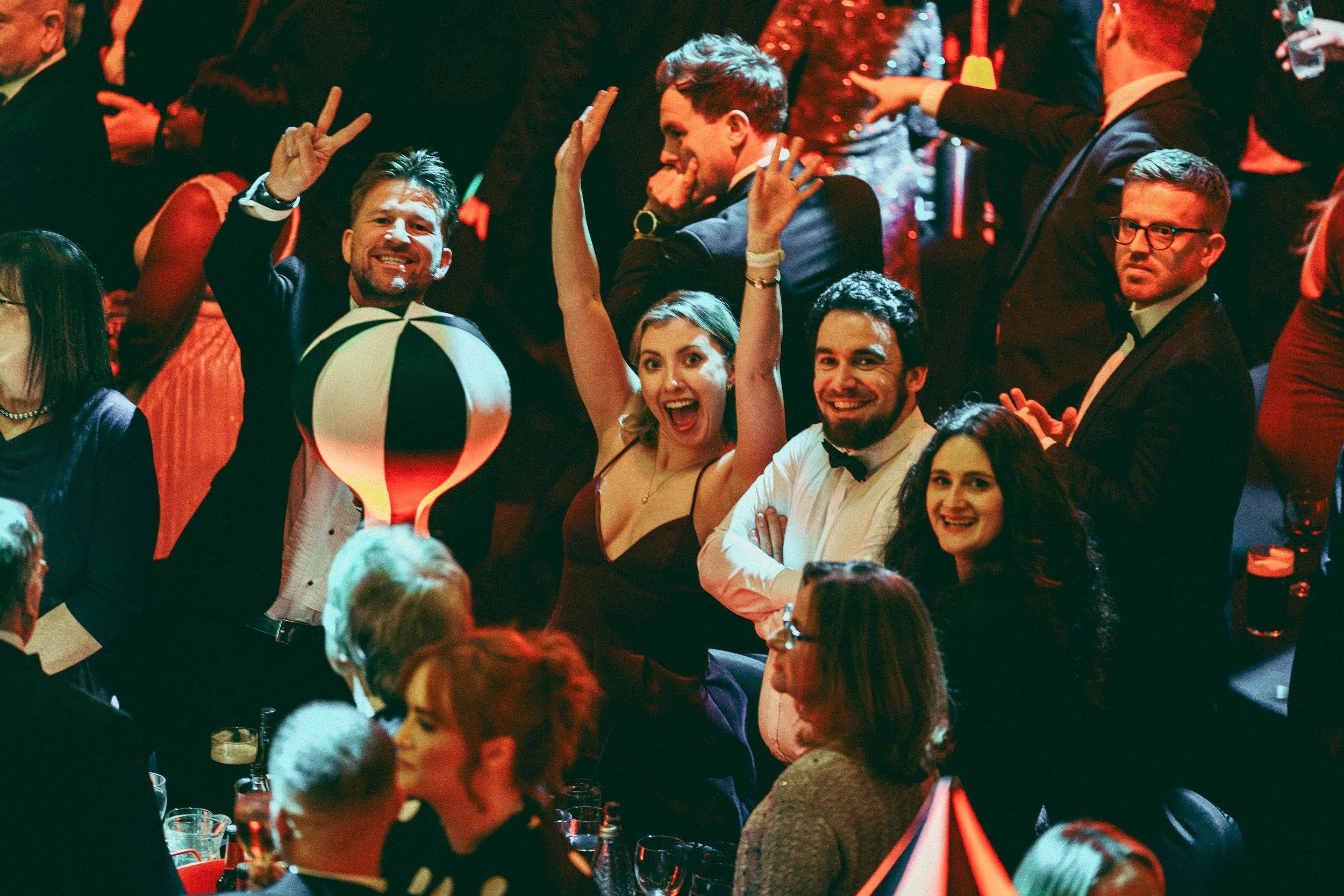 Audience members cheering and celebrating during an awards ceremony.
