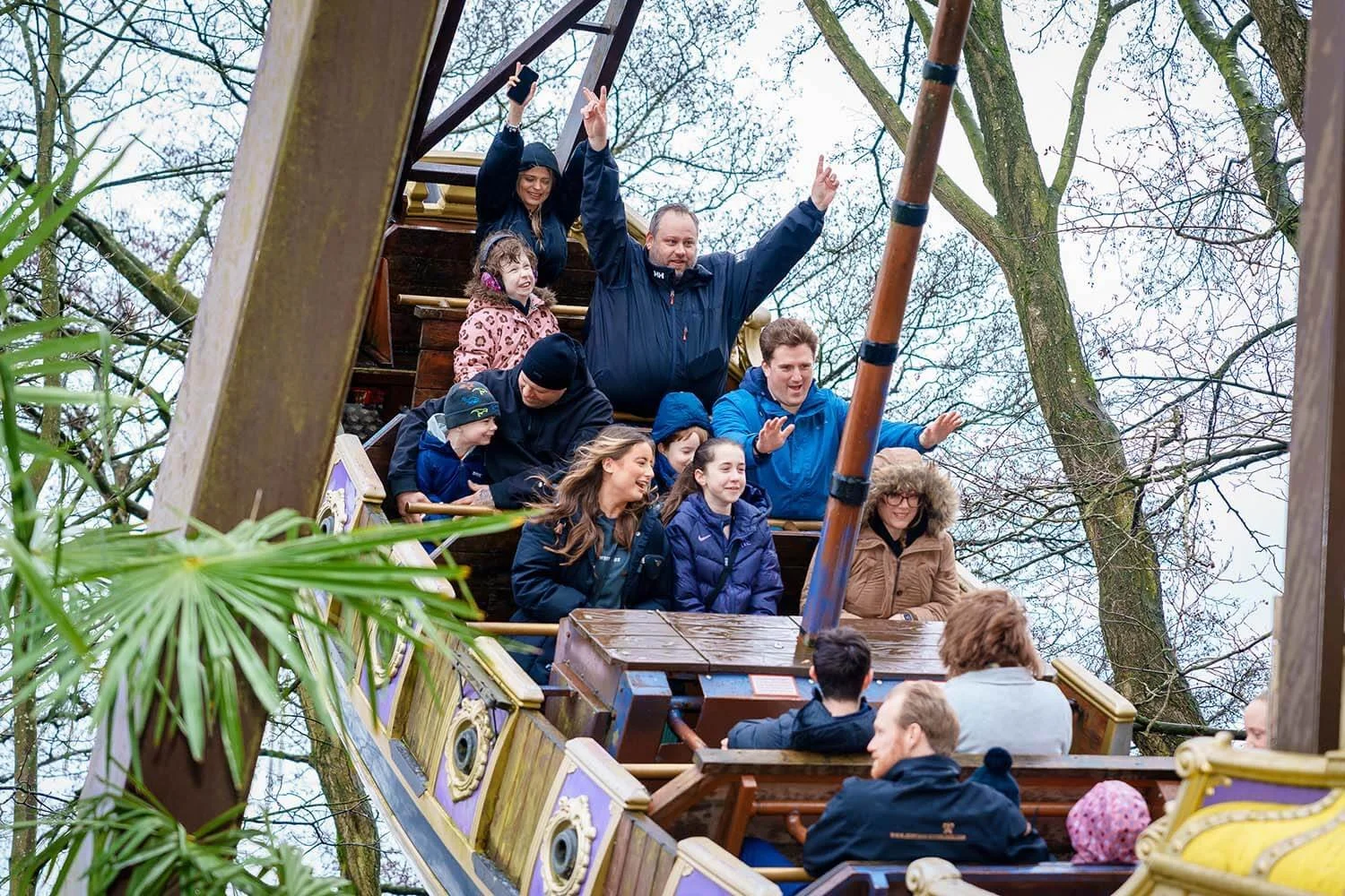 a group of people riding a ship shaped theme park attraction during a charitable community event