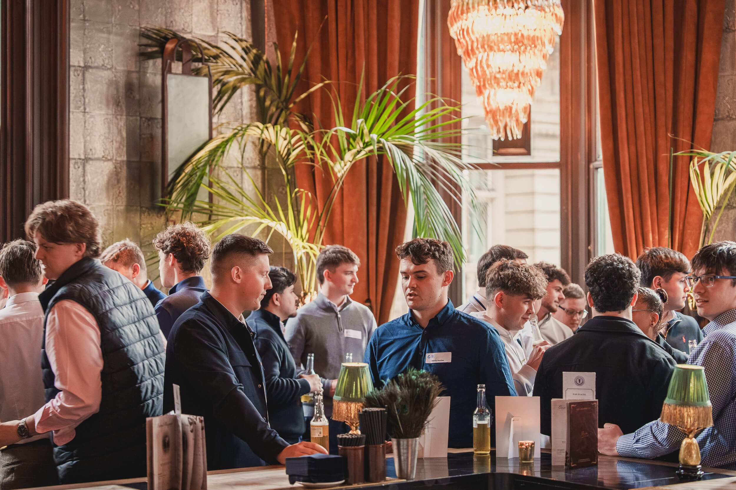 Guests talking over drinks during an evening business networking event.