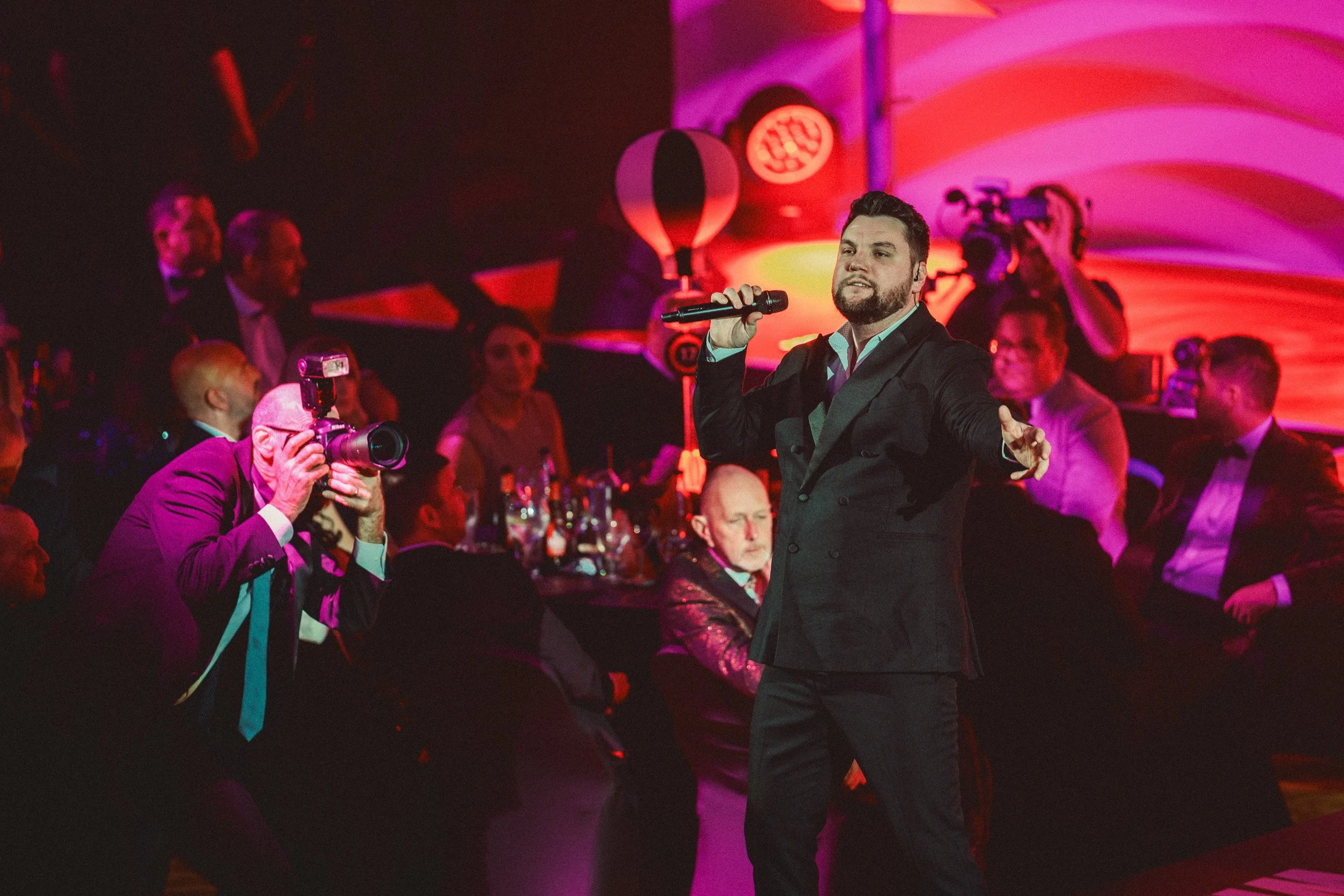 singer performing on stag at a corporate celebration event