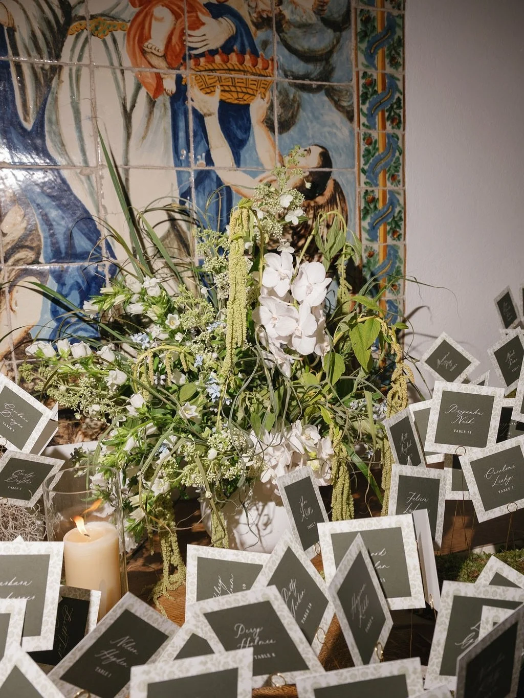 Mosaic tile walls, escort cards tucked into moss trays, and cascading, garden-inspired florals&hellip;This table assignment installation was truly a labor of love&mdash;brought to life through thoughtful collaboration with our stationery + signage ve