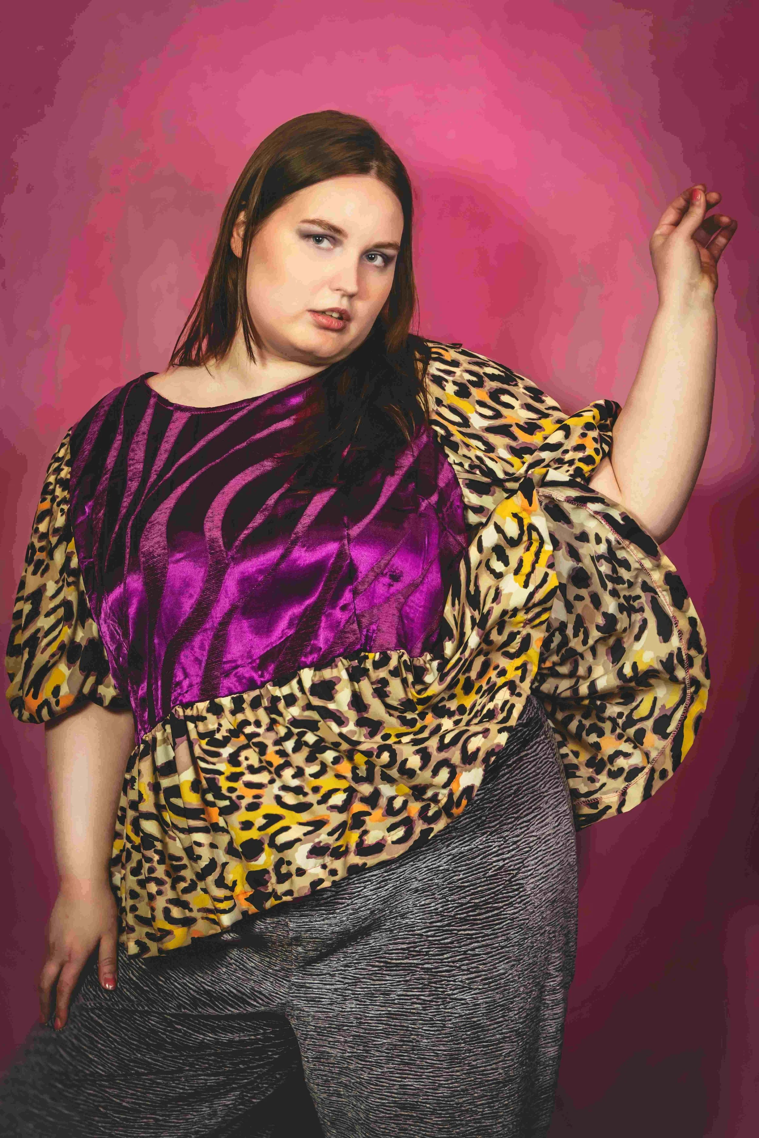 Plus size woman wearing colorful blouse looking beautiful.