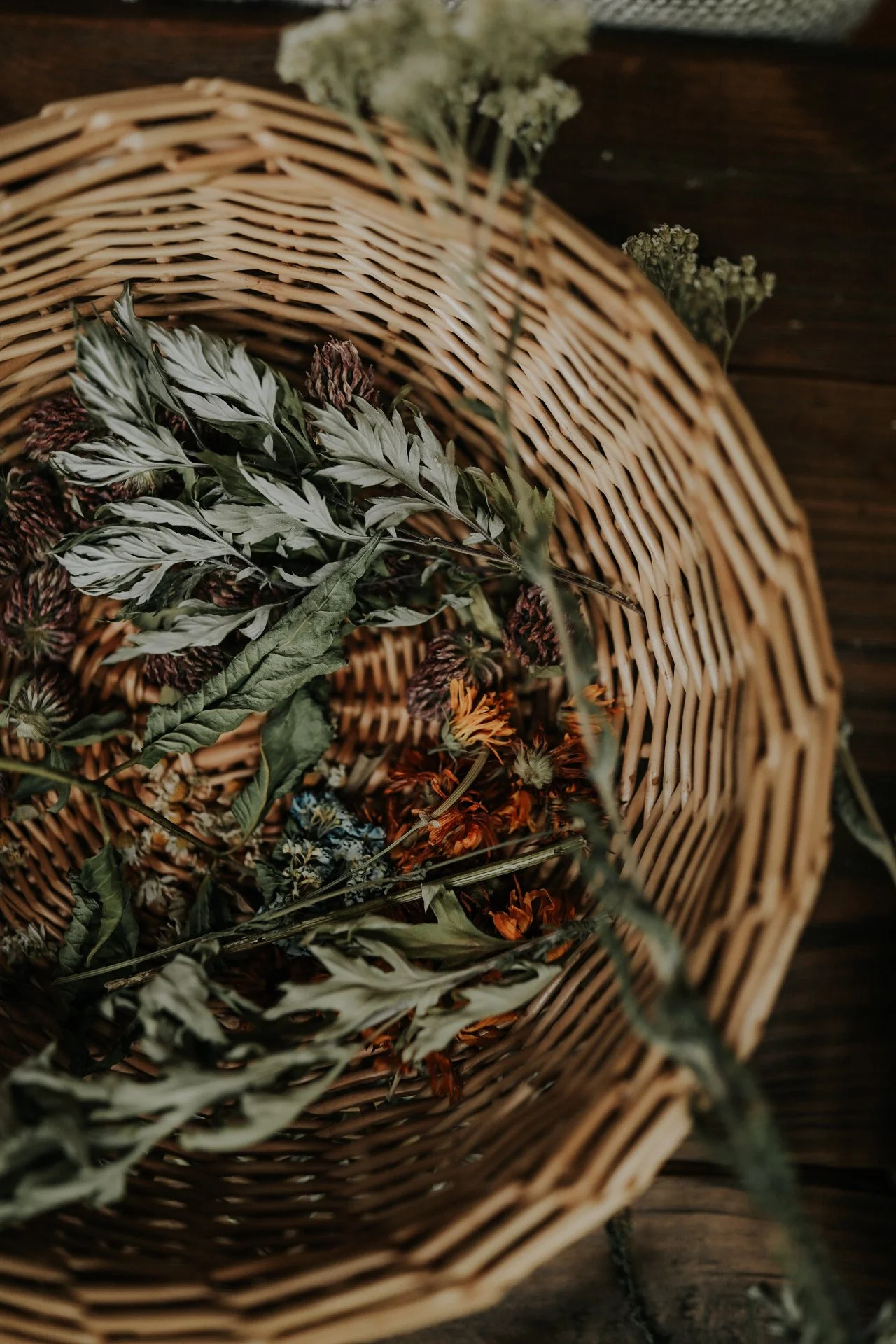 Woven basket with assorted dried flowers and leaves